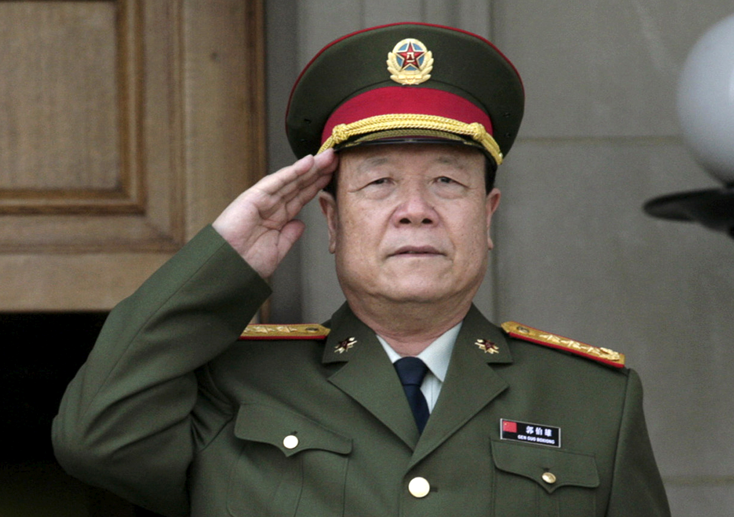 China's then Central Military Commission former Vice Chairman General Guo Boxiong stands at attention during the playing of the national anthem before a meeting at the Pentagon in Washington