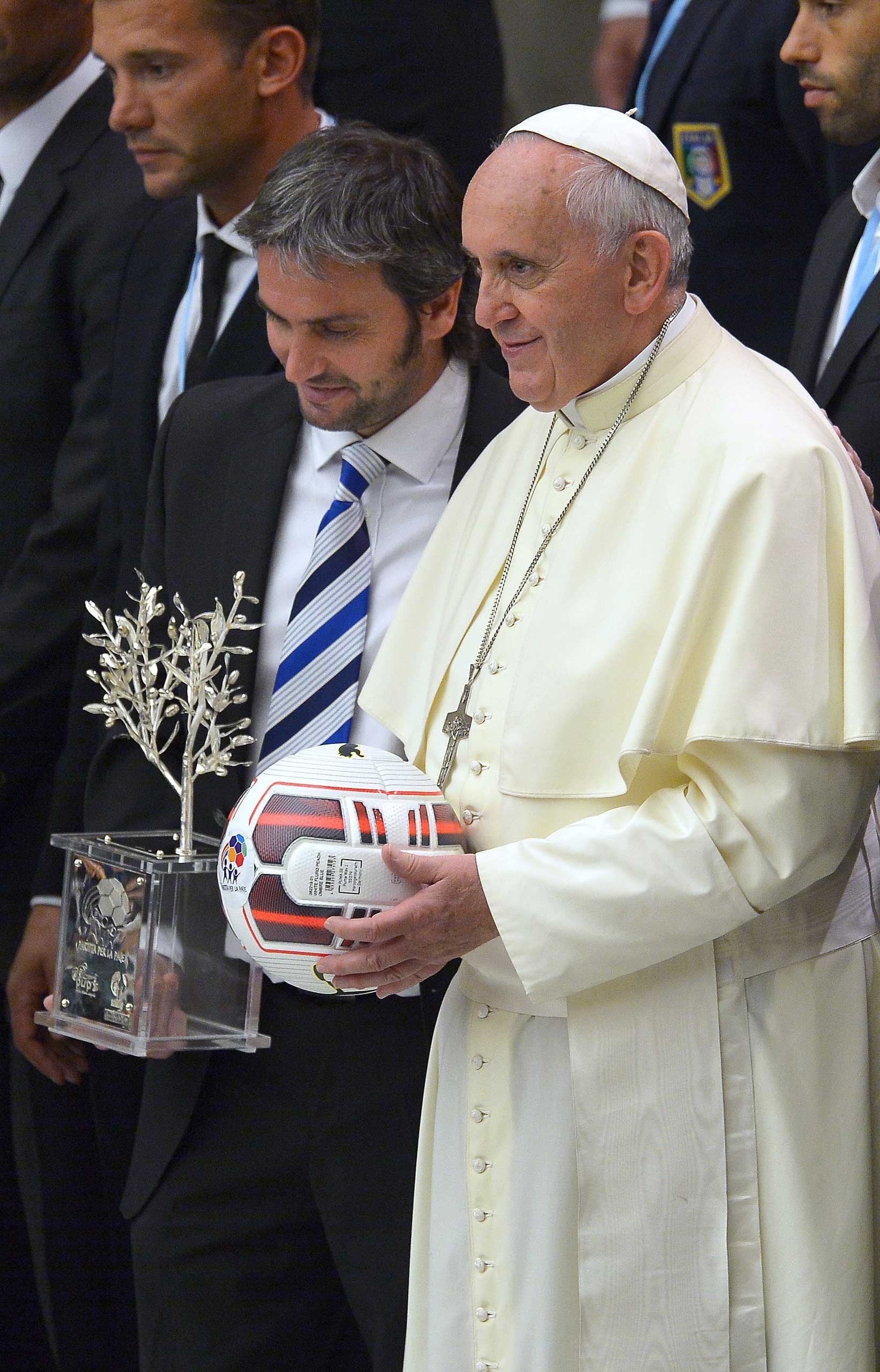 Pope Francis stands next to Argentinian craftsman Adrian Pallarols as he poses for the family photo with international football players at the Vatican on Sept. 2014 prior to an inter-religious "match for peace" soccer game that played at Rome's Olympic S