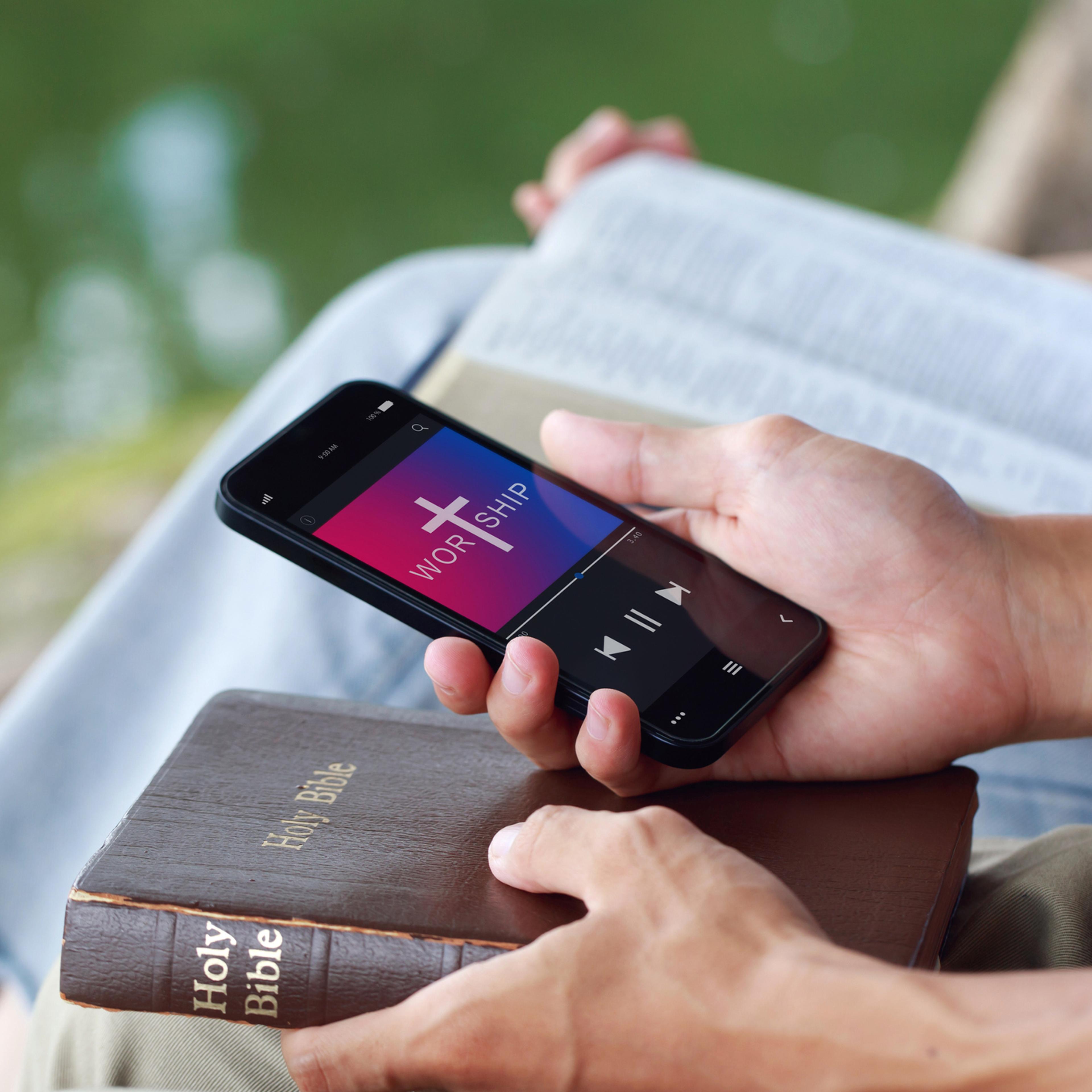 Christian friends group reading and study bible from mobile phones praying worship to GOD with church online Sunday in the garden at.Live Church with the bible. spirituality religion online concept