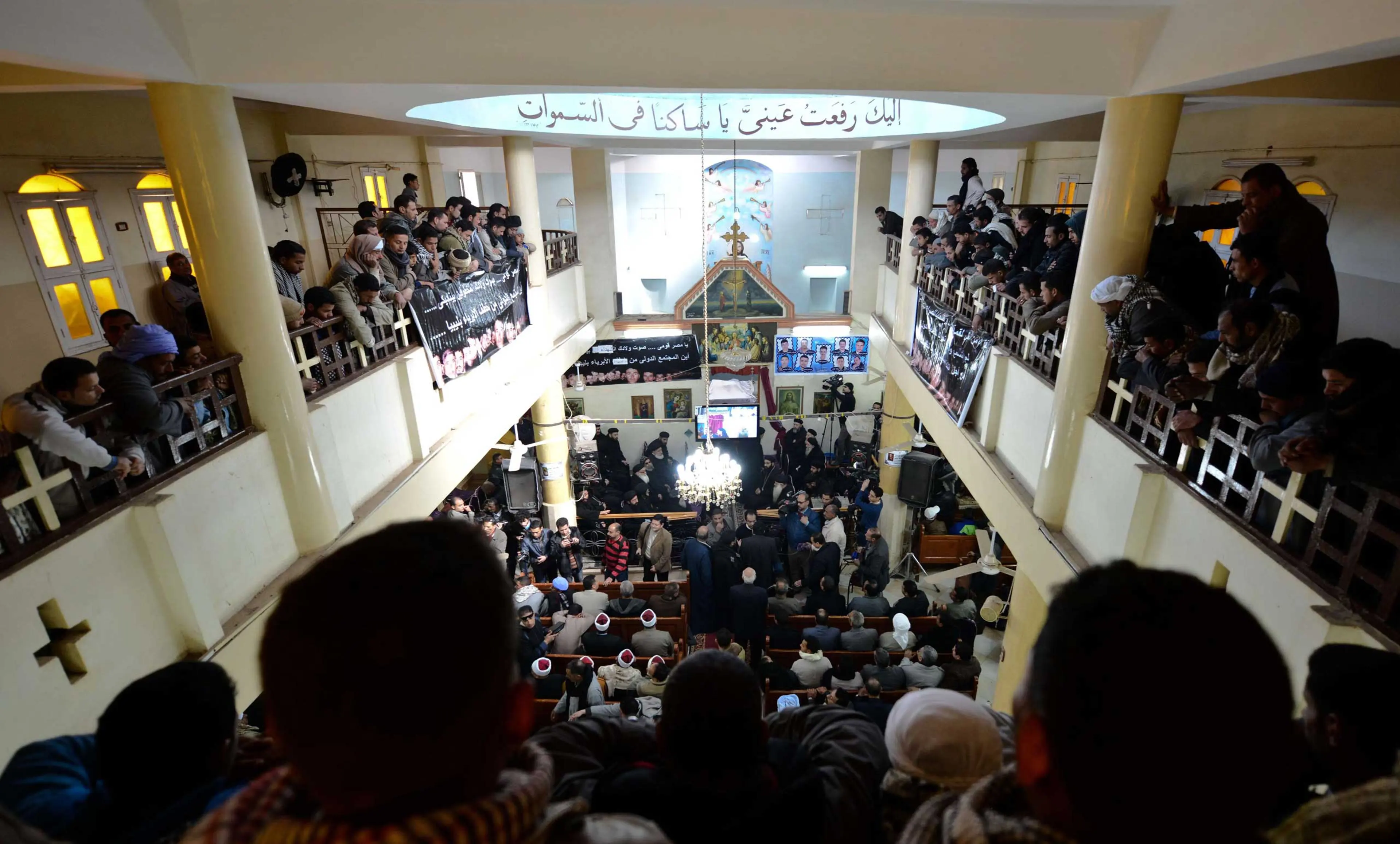 Egyptian Coptic Christians attend a memorial ceremony for relatives purportedly murdered by ISIS militants in Libya, on Feb. 16, 2015, in the village of al-Awar in Egypt's southern province of Minya.