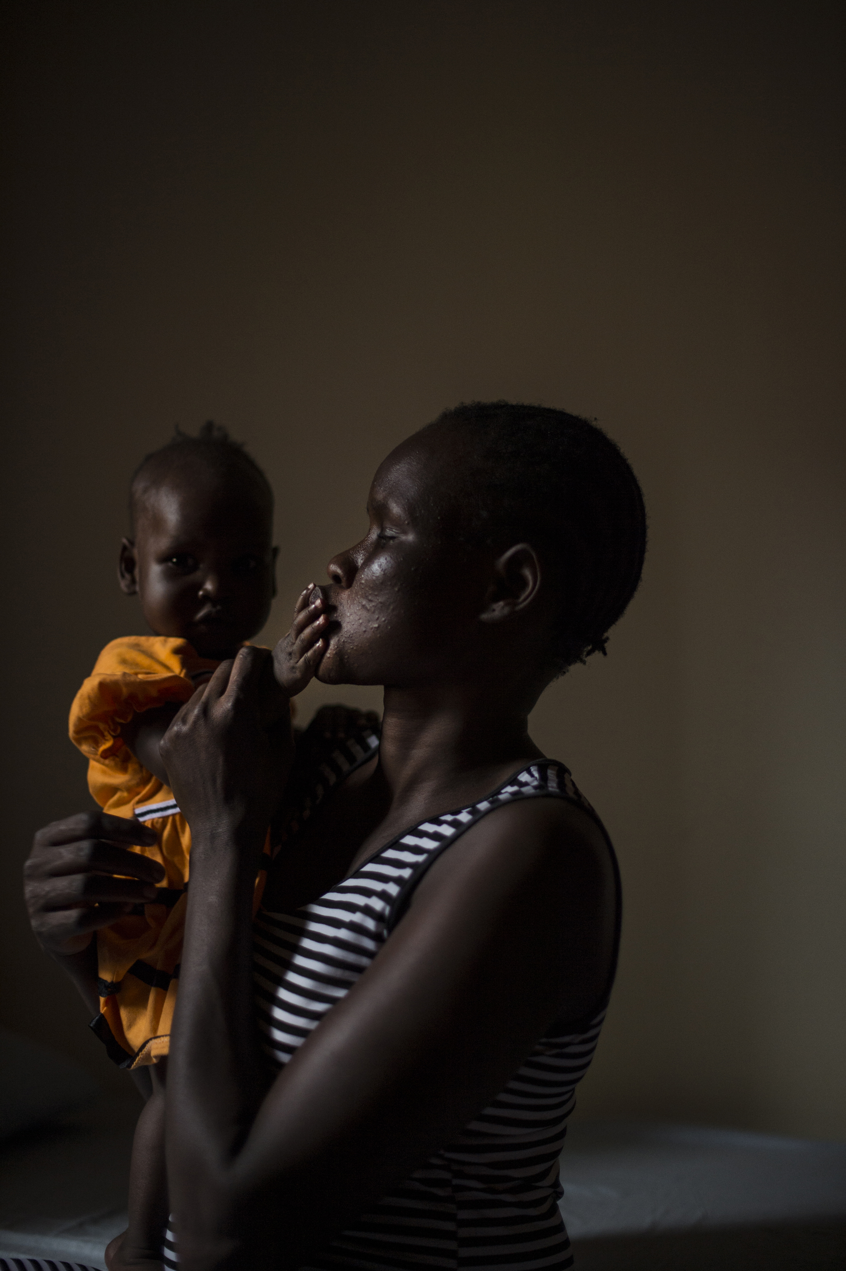 Mary, 27, holds her daughter, Nyakwat, 6 months old who was born after Mary was raped repeatedly at a U.N. camp in South Sudan by different men. She now lives in a safe house in Uganda, Dec. 8, 2015. Mary, a member of the Nuer tribe, watched as her husba