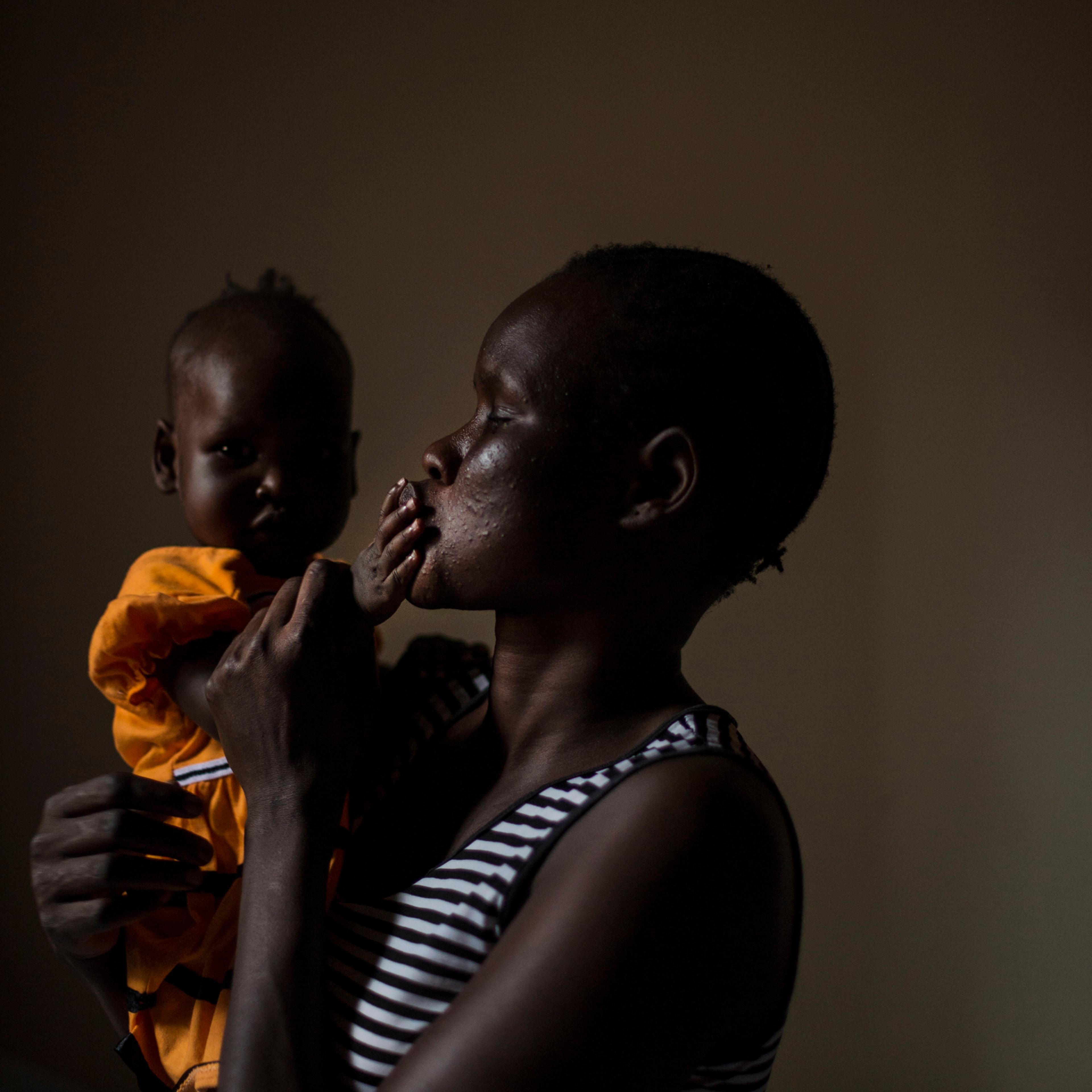 Mary, 27, holds her daughter, Nyakwat, 6 months old who was born after Mary was raped repeatedly at a U.N. camp in South Sudan by different men. She now lives in a safe house in Uganda, Dec. 8, 2015. Mary, a member of the Nuer tribe, watched as her husba