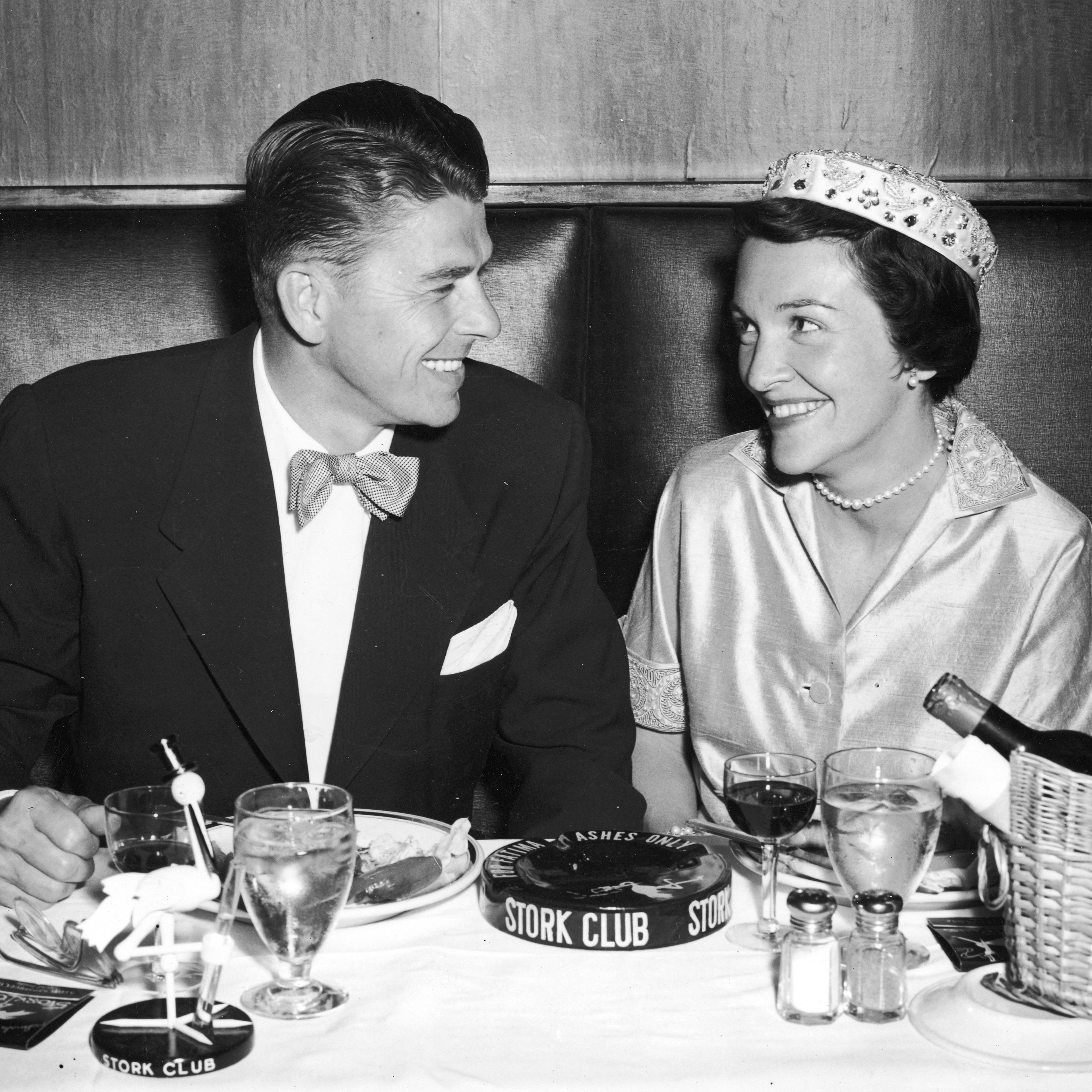 Ronald Reagan and his wife Nancy Reagan smile during their honeymoon dinner at the Stork Club in New York in 1952.