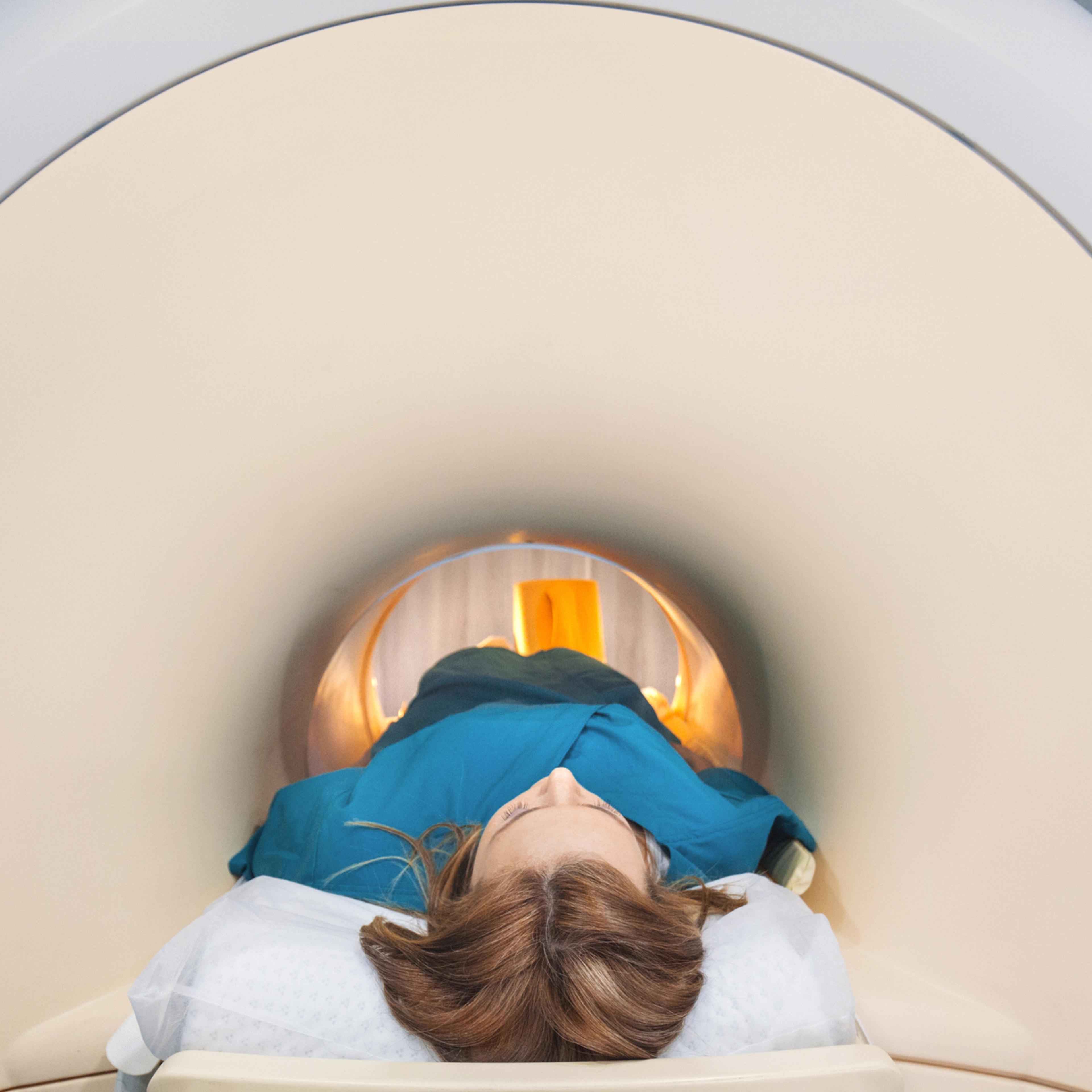 A woman enters an MRI scanner