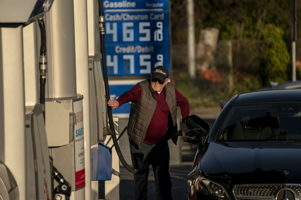 A customer refuels at a Chevron gas station in Seattle, where prices topped $4 a gallon on March 7. The following day, President Biden announced a ban on oil imports from Russia.