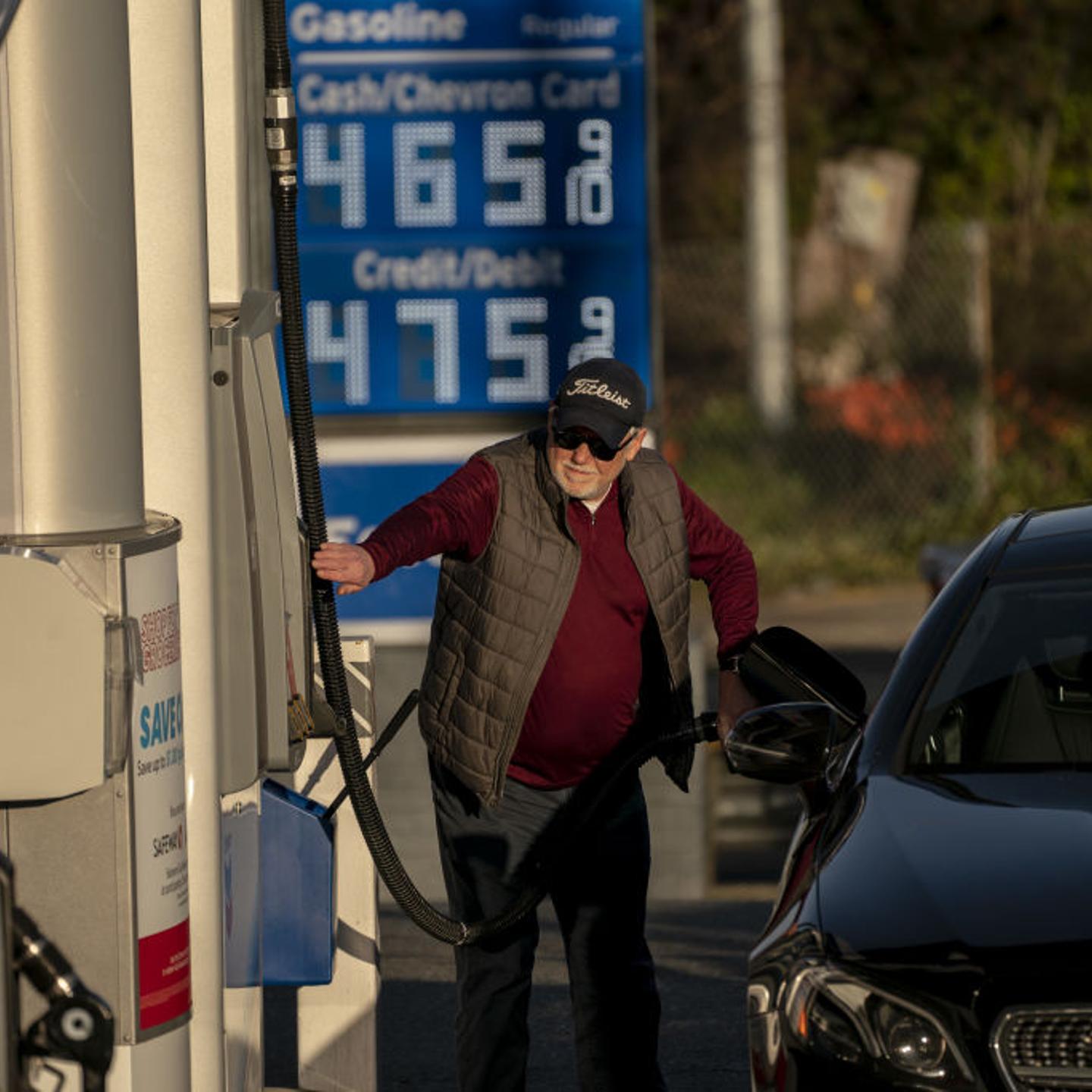 A customer refuels at a Chevron gas station in Seattle, where prices topped $4 a gallon on March 7. The following day, President Biden announced a ban on oil imports from Russia.
