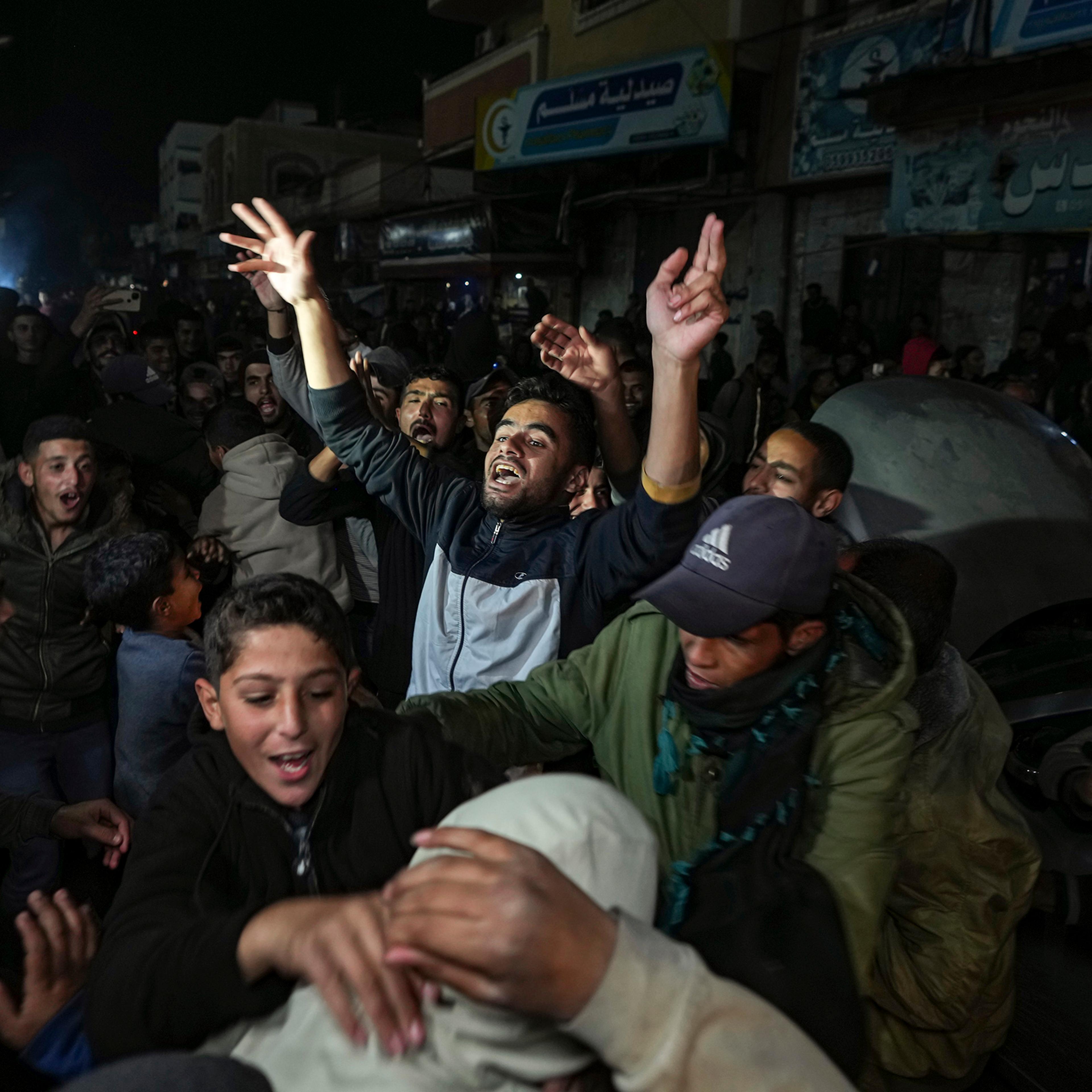 Palestinians celebrate the announcement of a ceasefire deal between Hamas and Israel in Deir al-Balah, central Gaza Strip, Jan. 15, 2025.