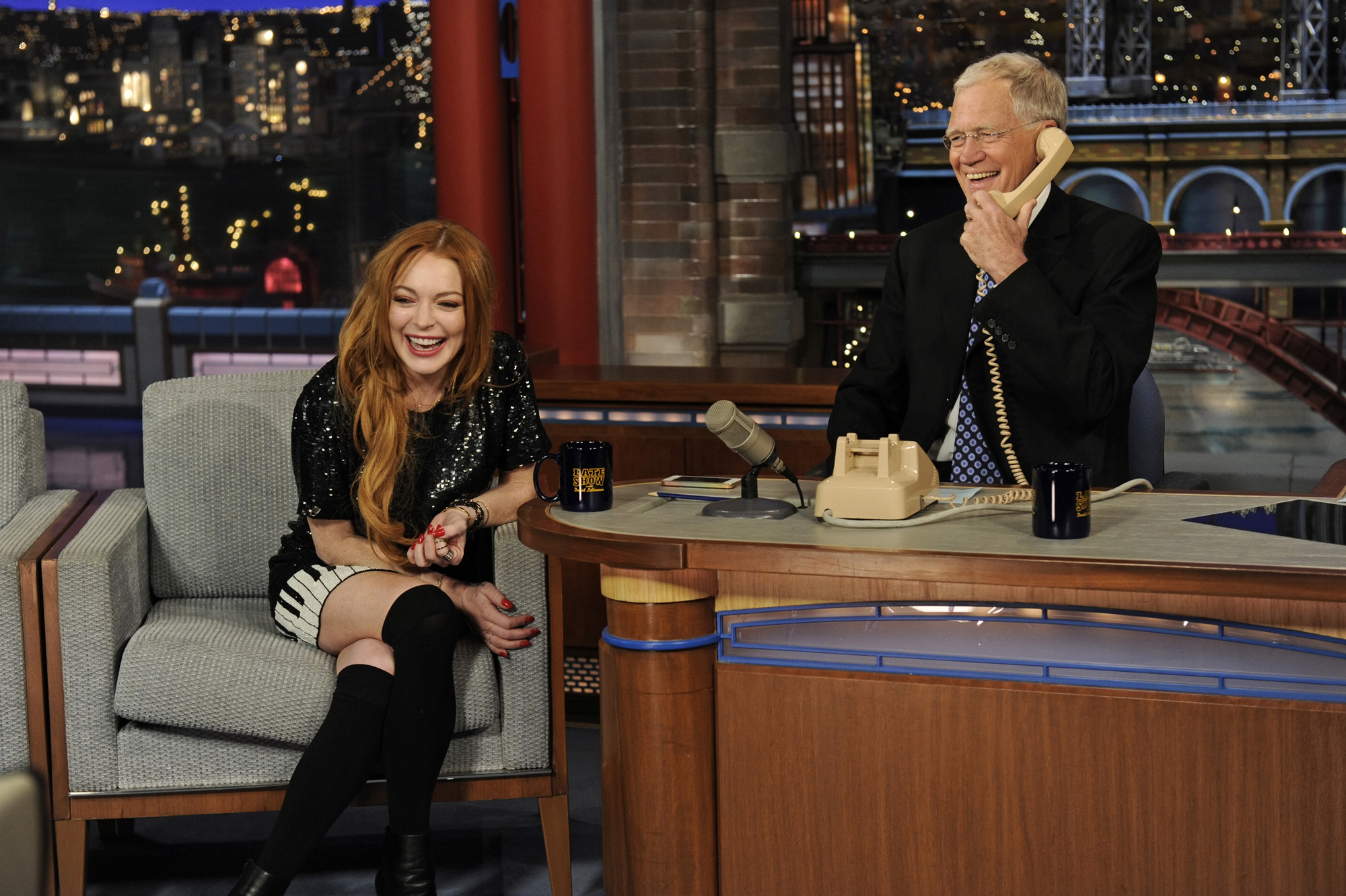 From right: David Letterman and Lindsay Lohan call Oprah Winfrey when Lohan visits the Late Show with David Letterman on April 9, 2014 in New York City.