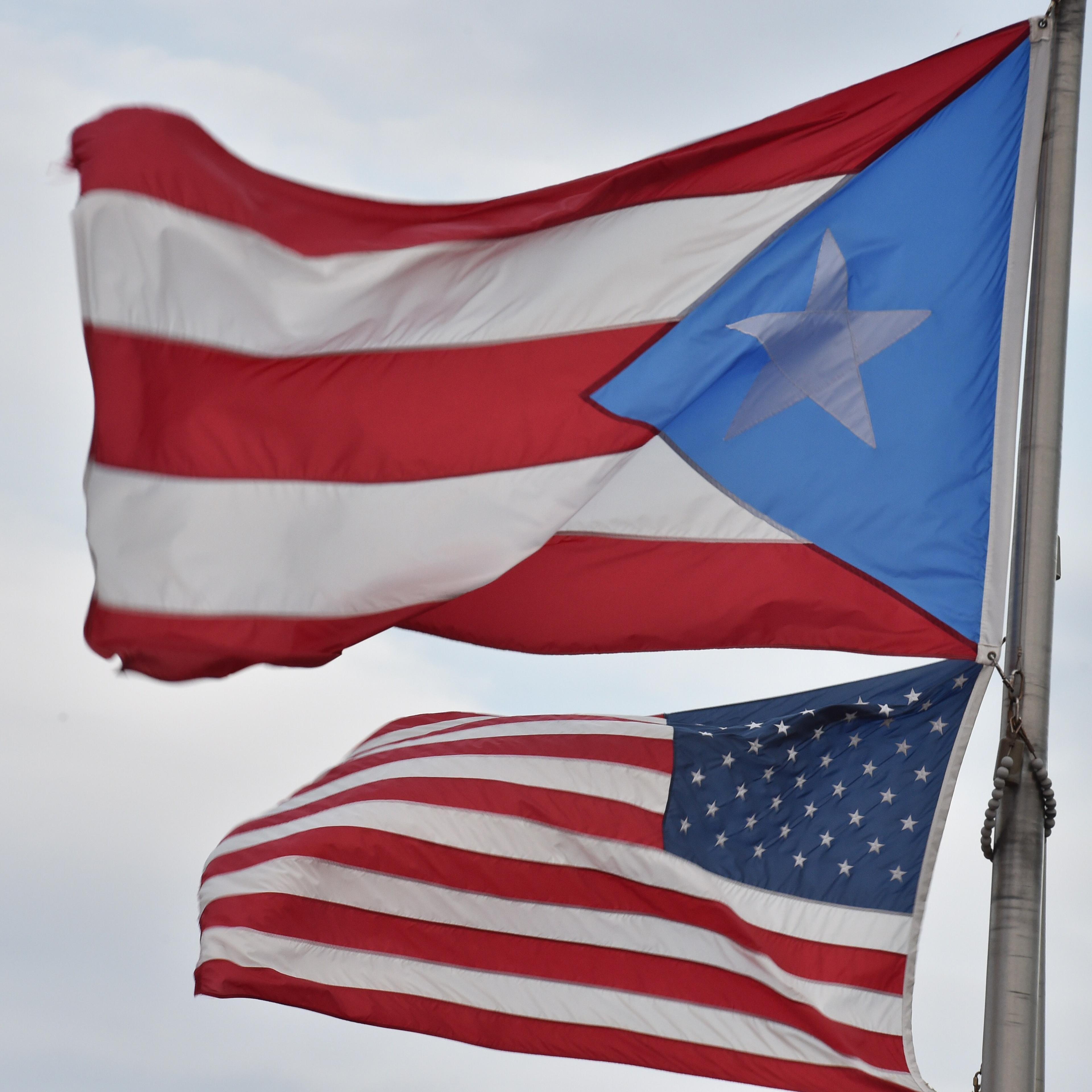 The Puerto Rican and US flags are seen in the Old Town district Feb. 9, 2015 in San Juan, Puerto Rico.
