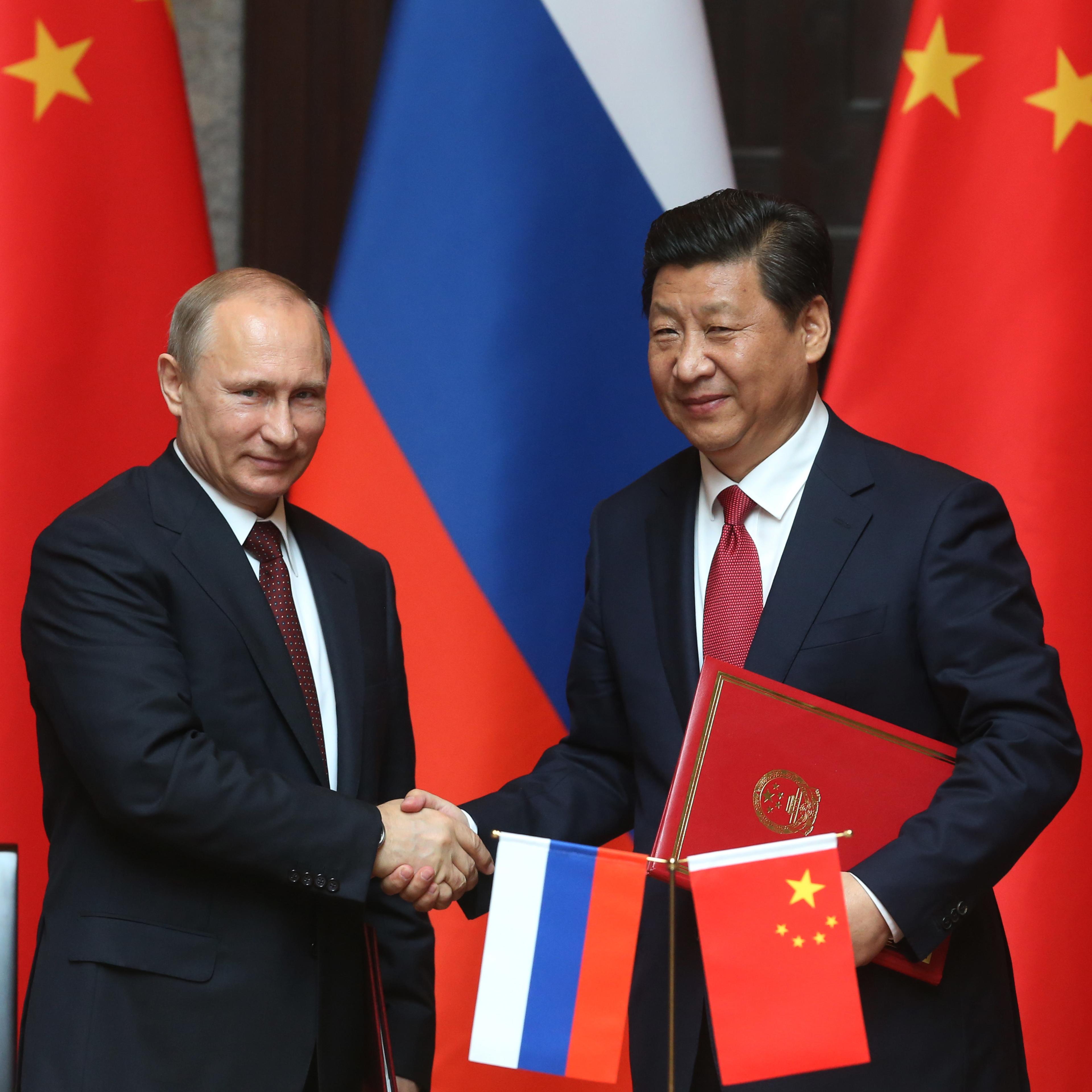 Russian President Vladimir Putin and Chinese President Xi Jingping attend a welcoming ceremony on May 20, 2014 in Shanghai.