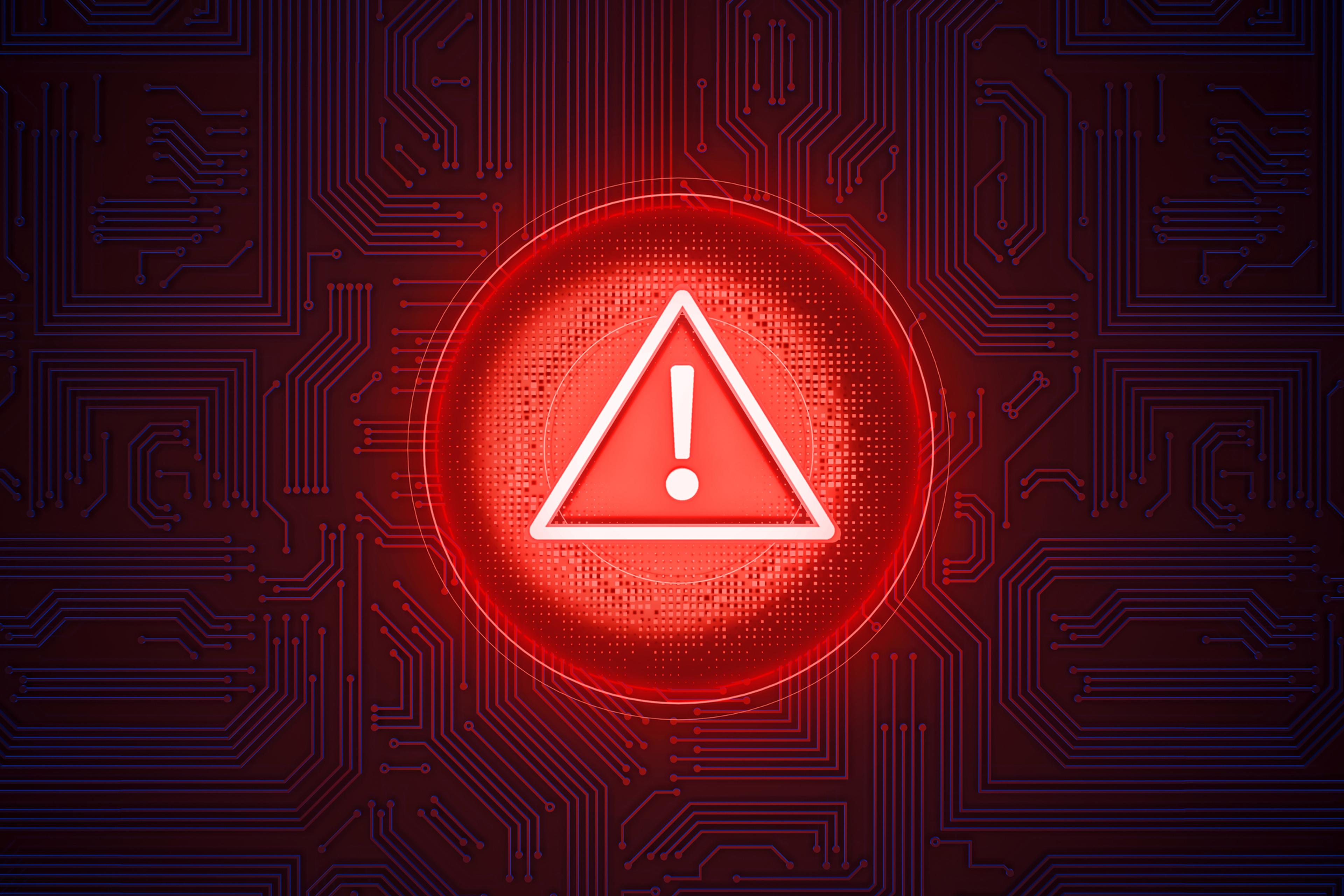Warning Sign of digital risk: A luminous red warning sign in the shape of a circle with an exclamation mark centered, stands out against a dark tech background