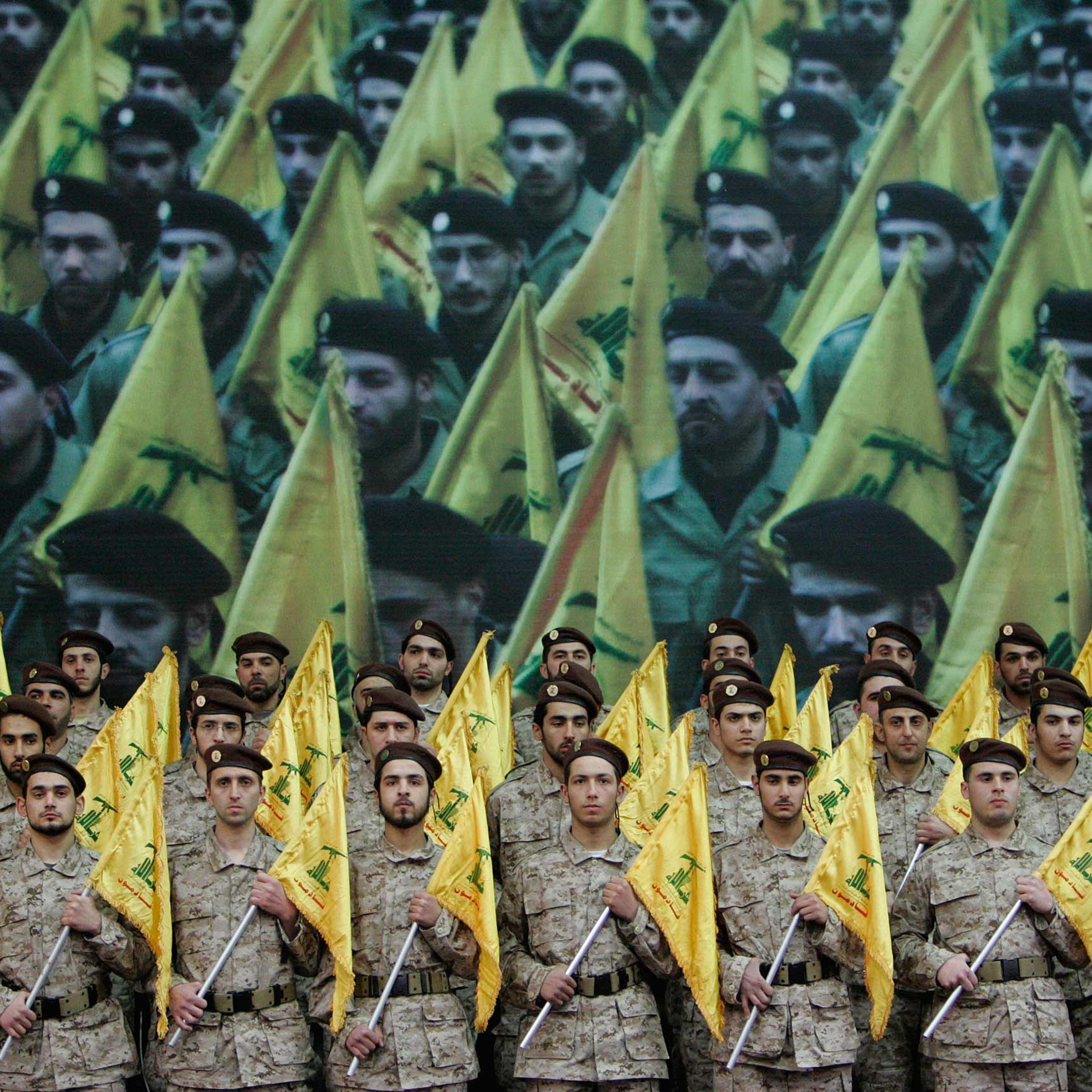Hezbollah fighters hold their party flags as they attend a rally to commemorate slain top Hezbollah commander Imad Mughniyeh and two other leaders, Abbas Musawi and Ragheb Harb, in the Shiite suburb of Beirut, Feb. 22, 2008.