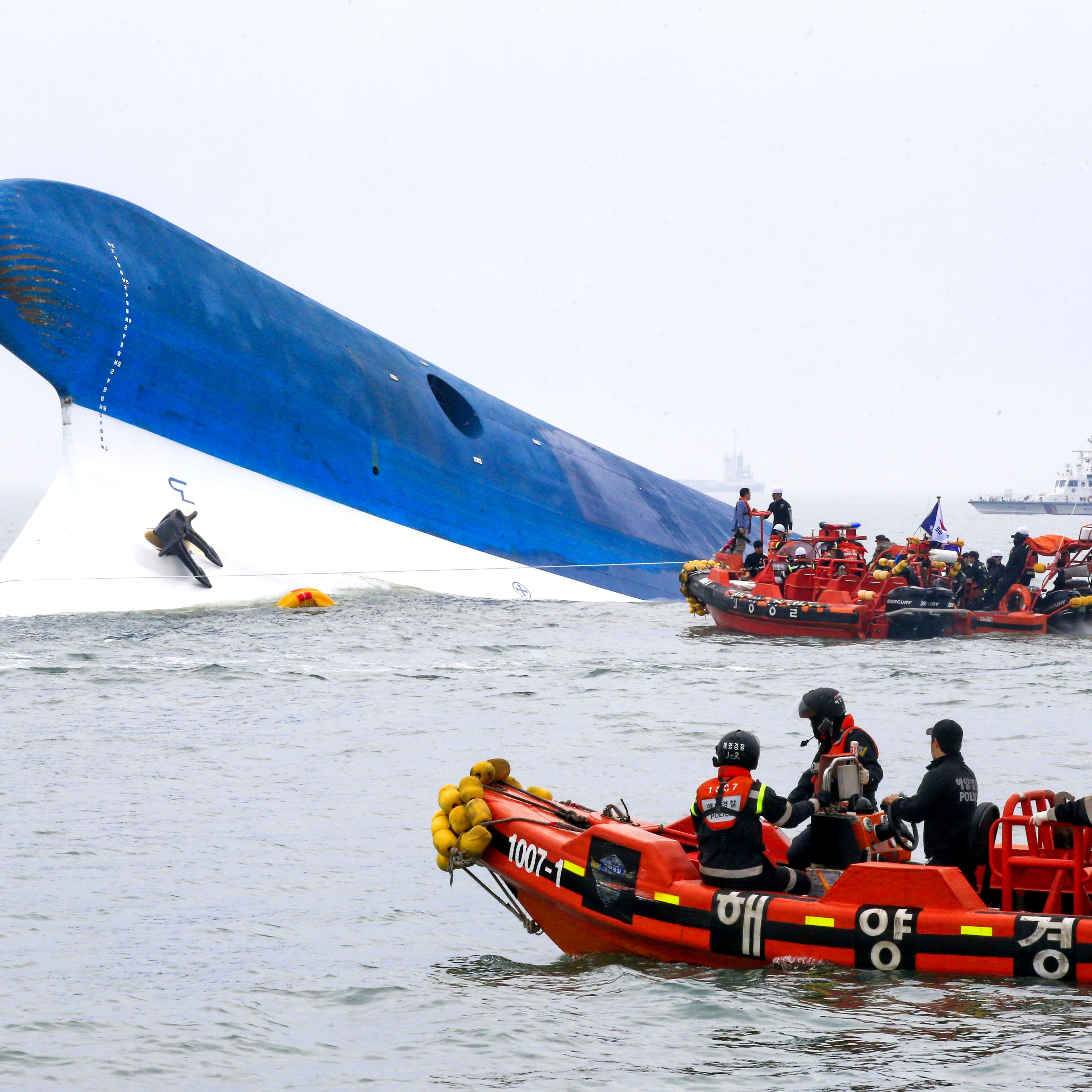 Coast guard members search for passengers near a South Korean ferry that capsized on its way to Jeju island from Incheon on April 16, 2014.