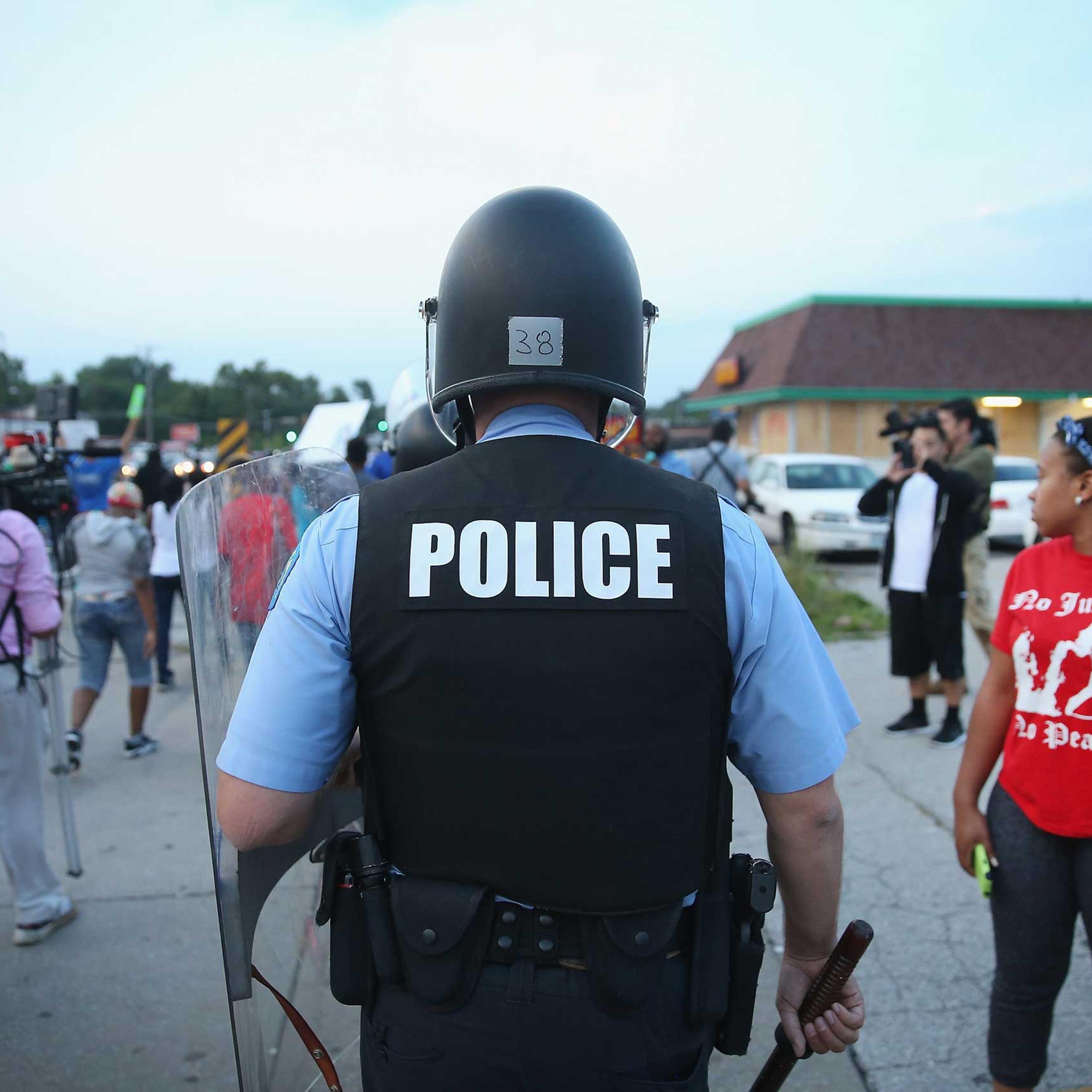Police are deployed to keep peace along Florissant Avenue in Ferguson, Mo. on Aug. 16, 2014.