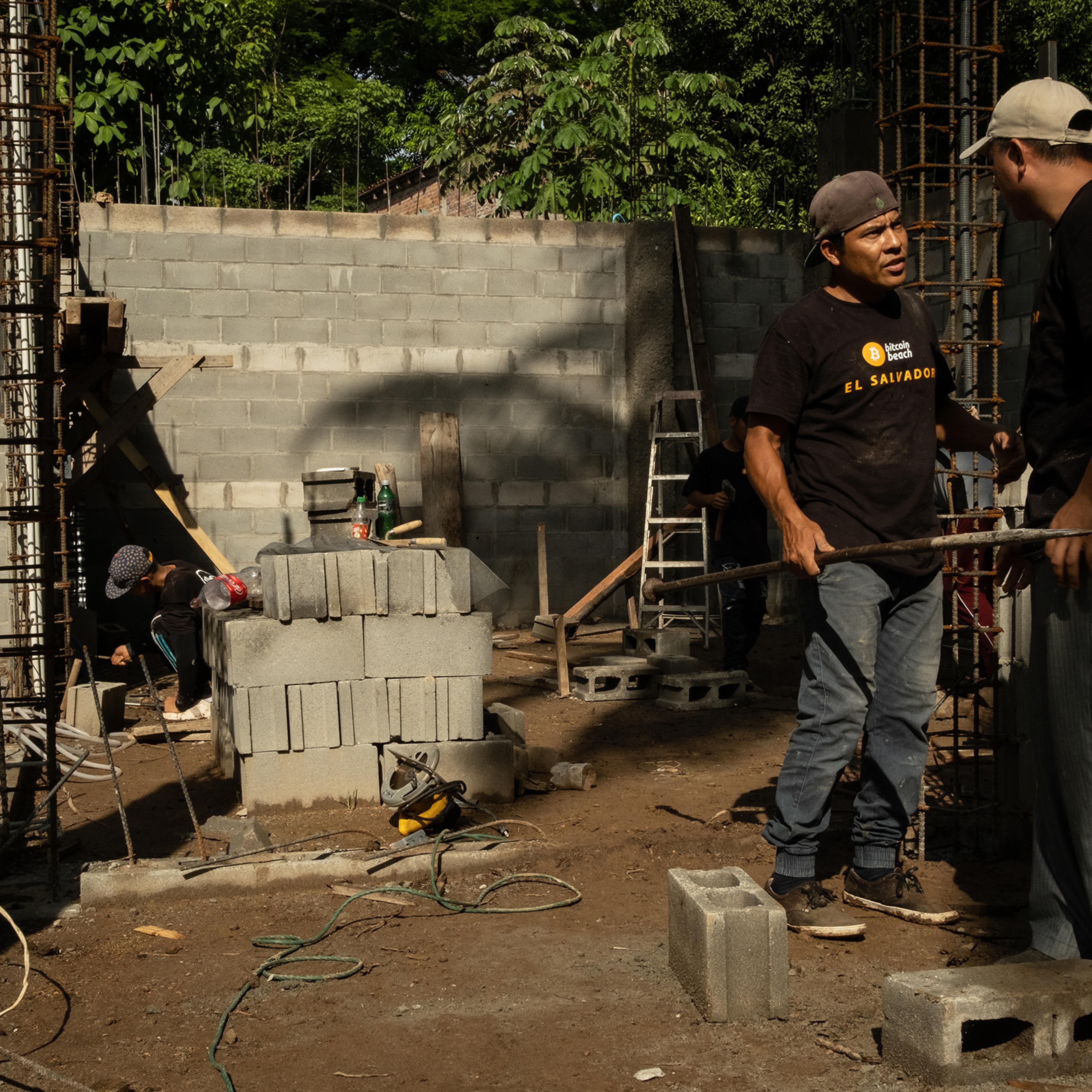 Construction workers, who are paid in bitcoin, work on a building outside the "bitcoin beach" office in El Zonte, El Salvador, on June 14, 2021.