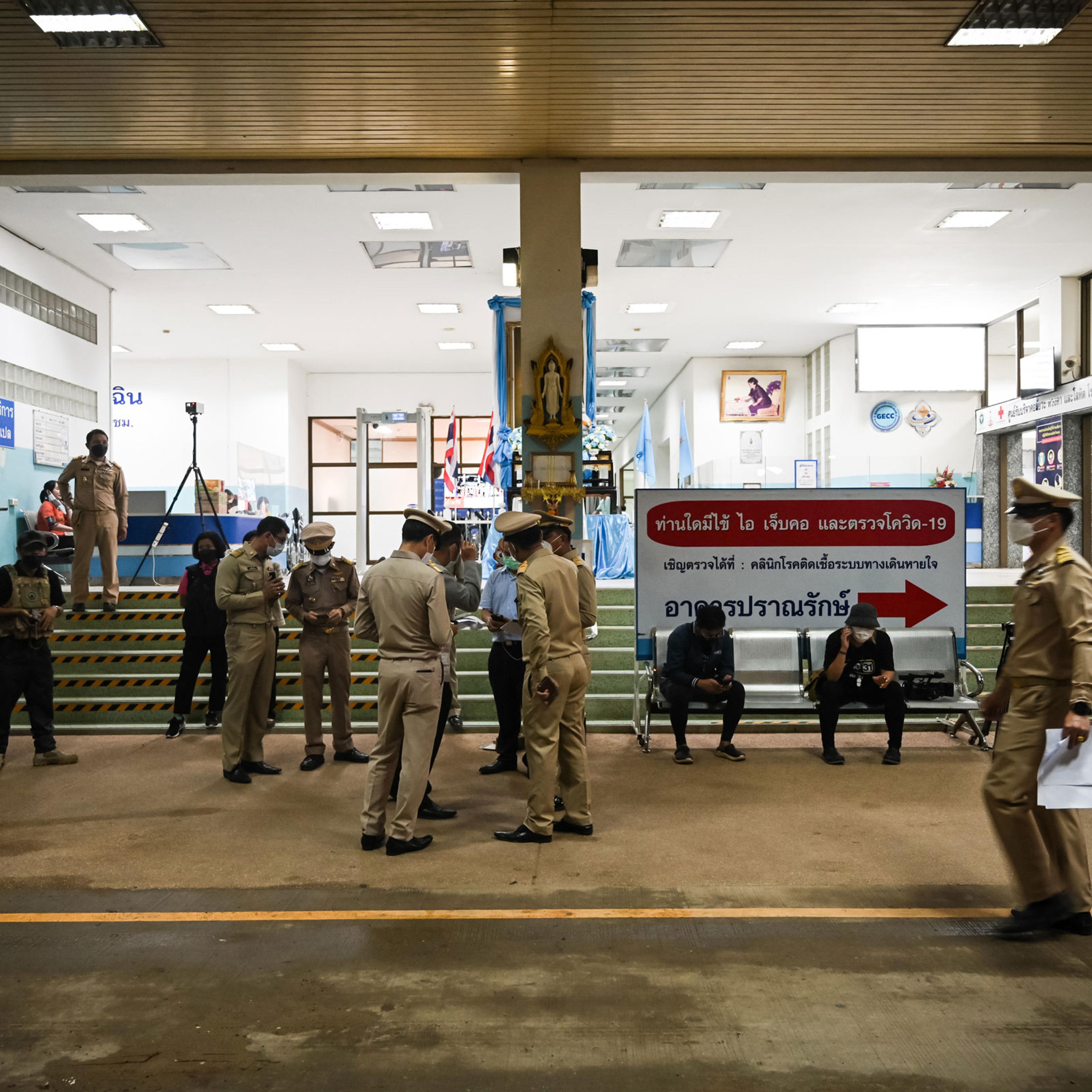 Police officers stand outside a hospital where the injured are being treated on Oct. 6, 2022 after a shooting in Uthai Sawan subdistrict, Nong Bua Lamphu, Thailand.