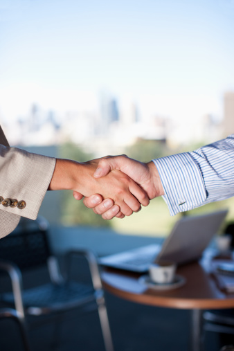 people-shaking-hands-cafe
