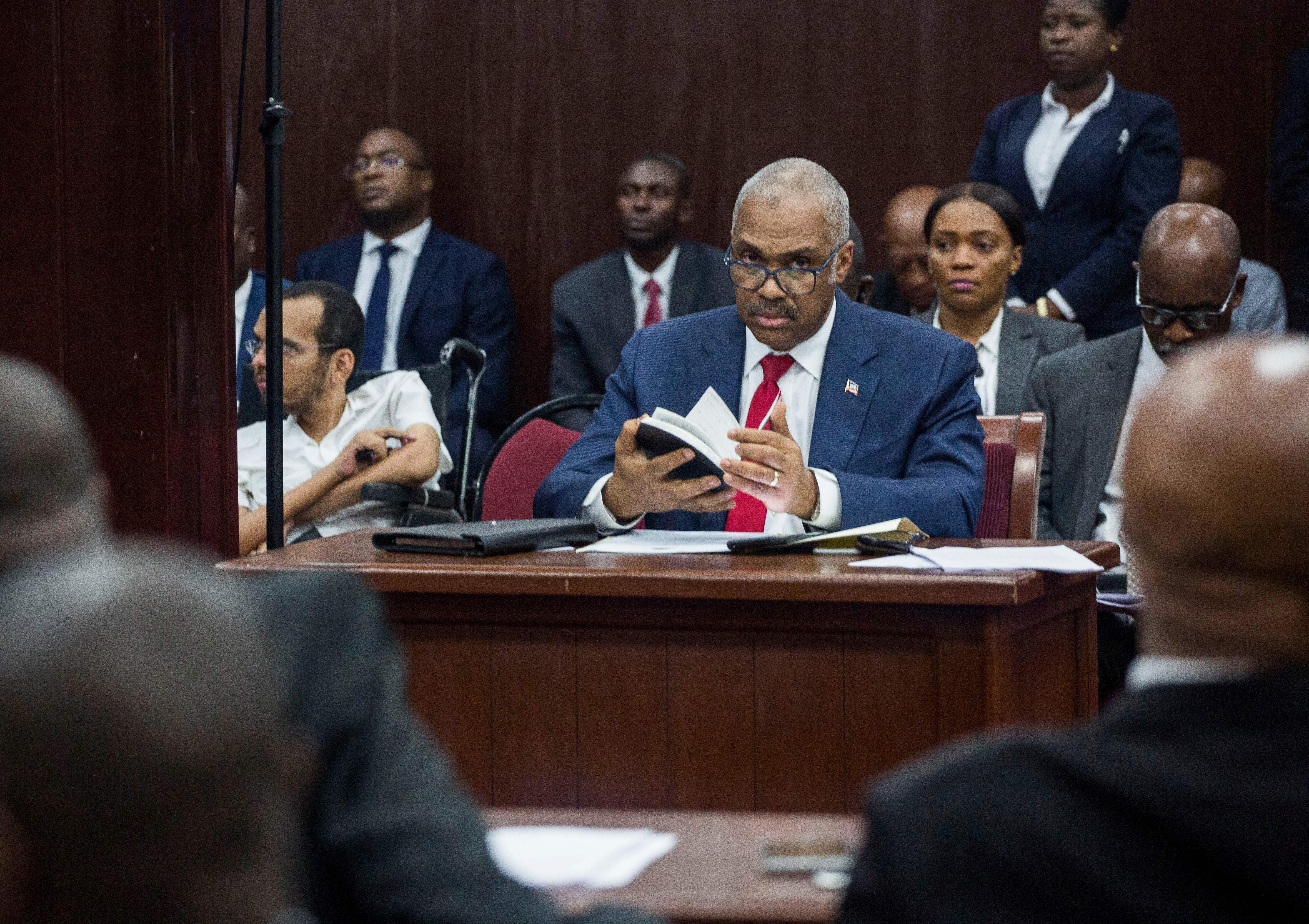 Lafontant sits at a desk for Parliament