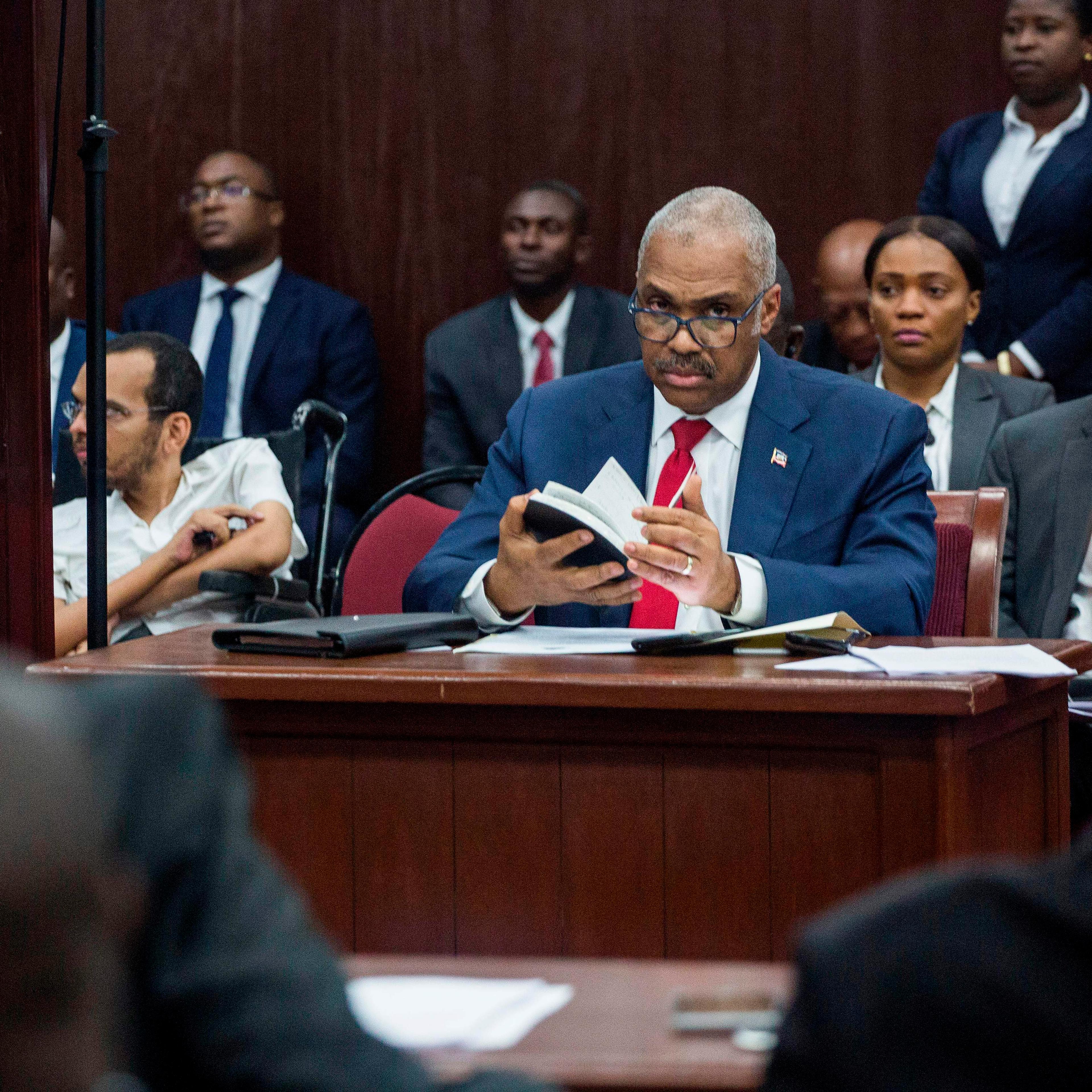Lafontant sits at a desk for Parliament