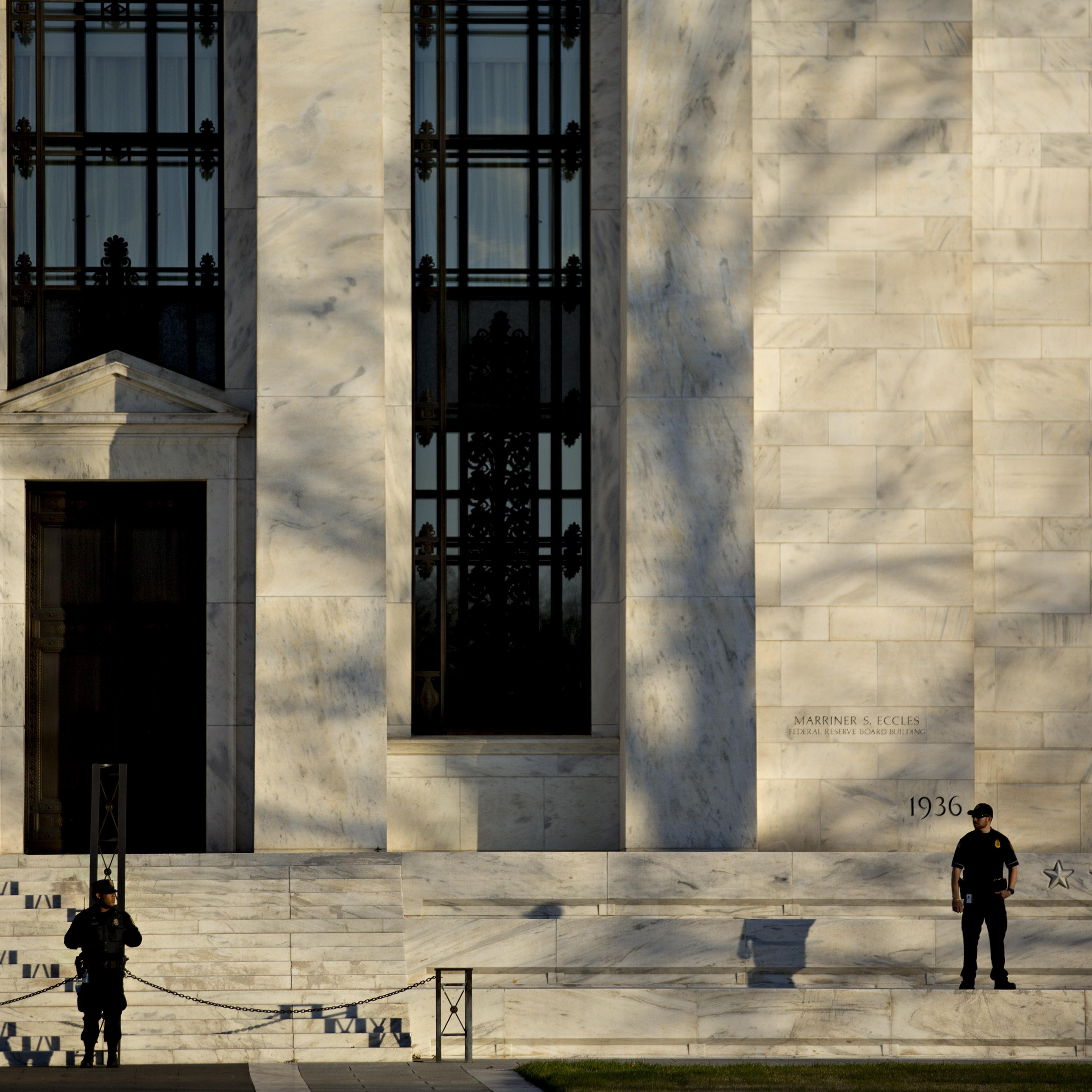 Federal Reserve police officers stand in front of the Marriner S. Eccles Federal Reserve building in Washington, D.C., on Dec. 15, 2015.