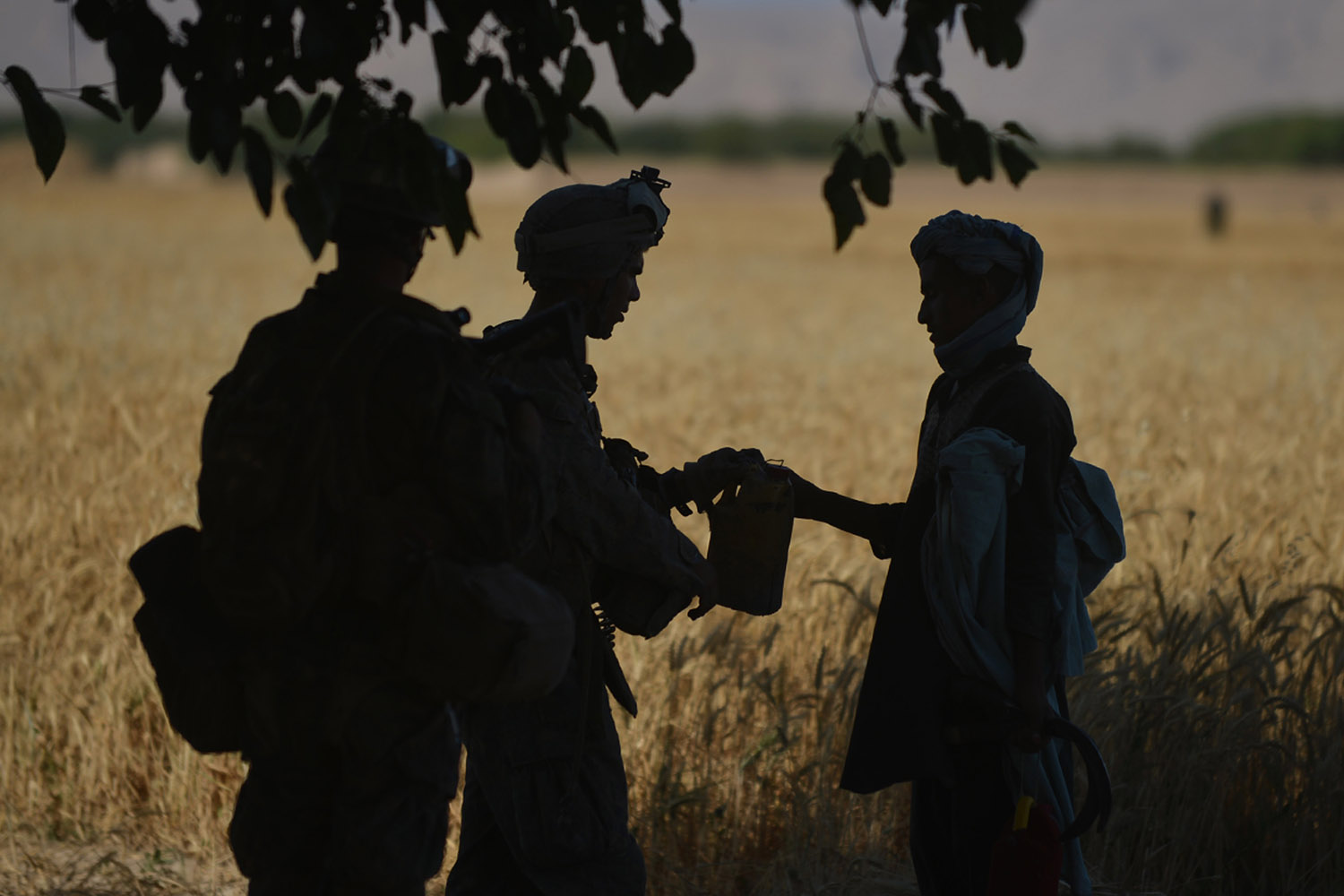 June 10, 2012. U.S. Marines check a farmer while in Sangin in Afghanistan. 