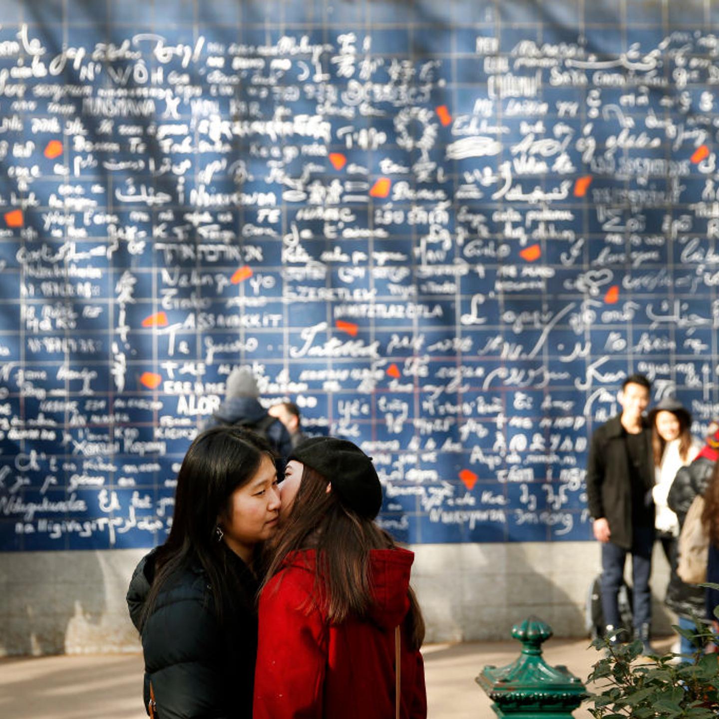 A couple kiss in front of « The wall of I love you » (Le mur des je t’aime) on the eve of the Valentine's Day