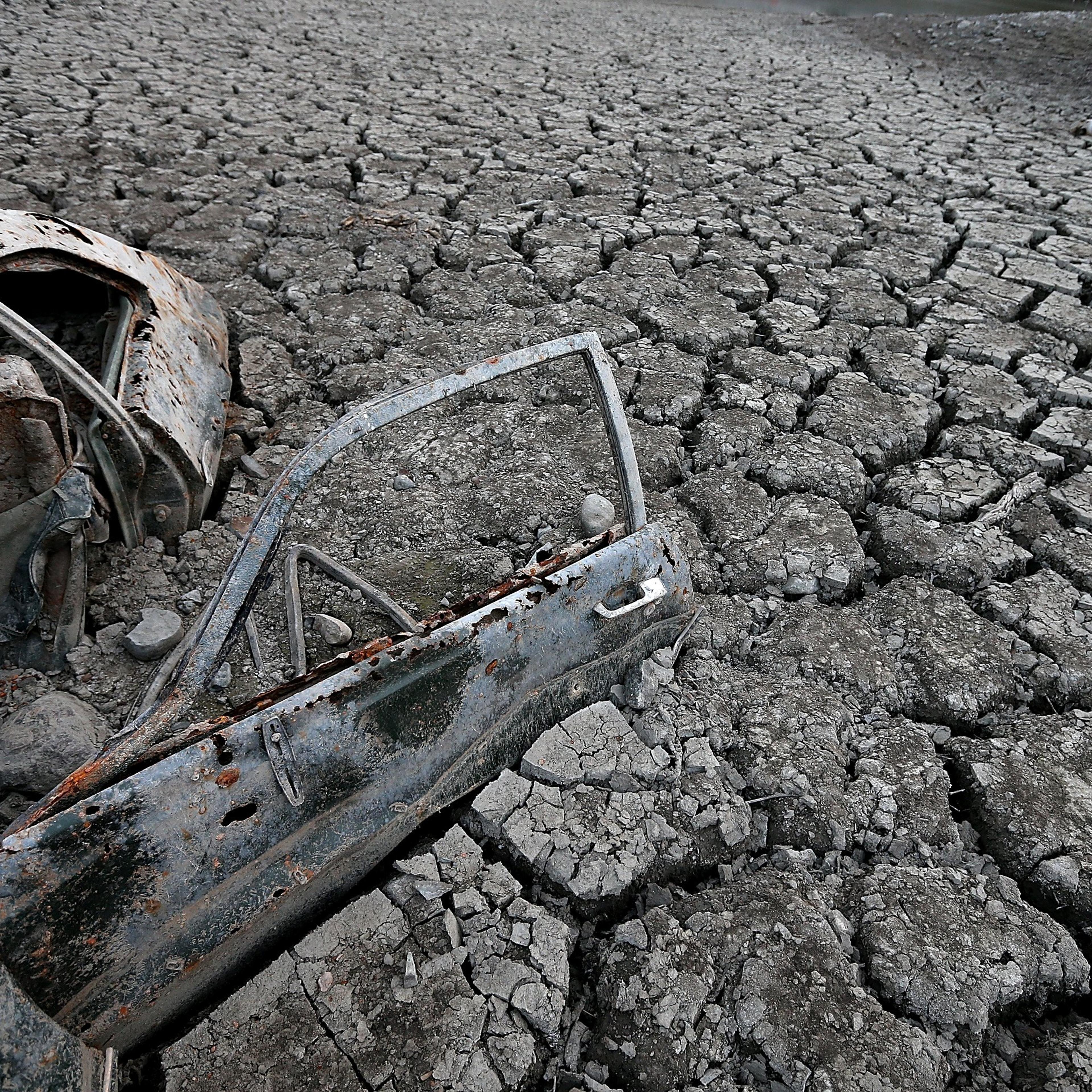 A car sits in dried and cracked earth of what was the bottom of the Almaden Reservoir on Jan. 28, 2014 in San Jose, California.
