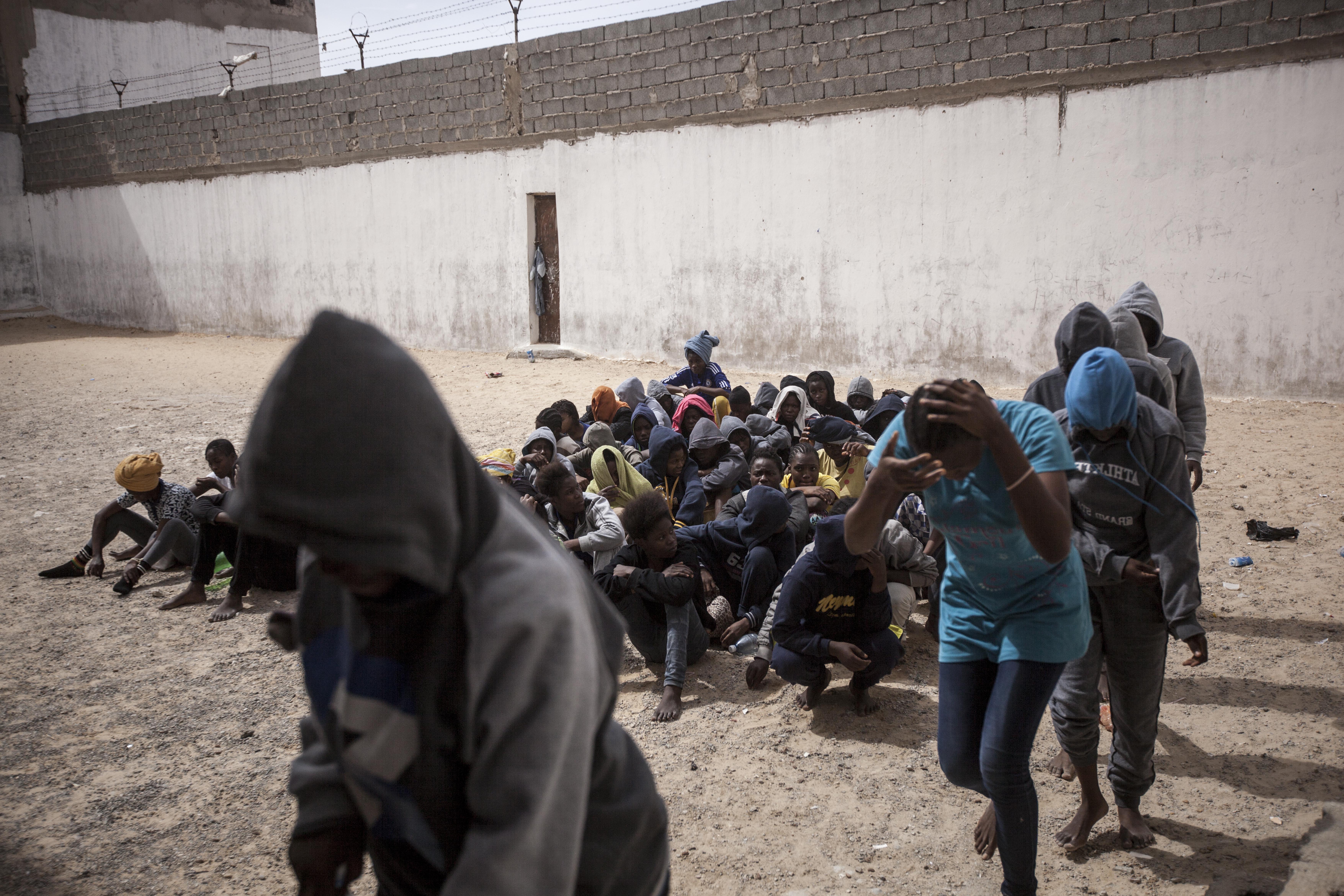 Women refugees and migrants queue in the prison yard as they are loaded onto buses to be transferred to another detention center. They were sold by a militia group ruling the Surman detention camp, Libya.