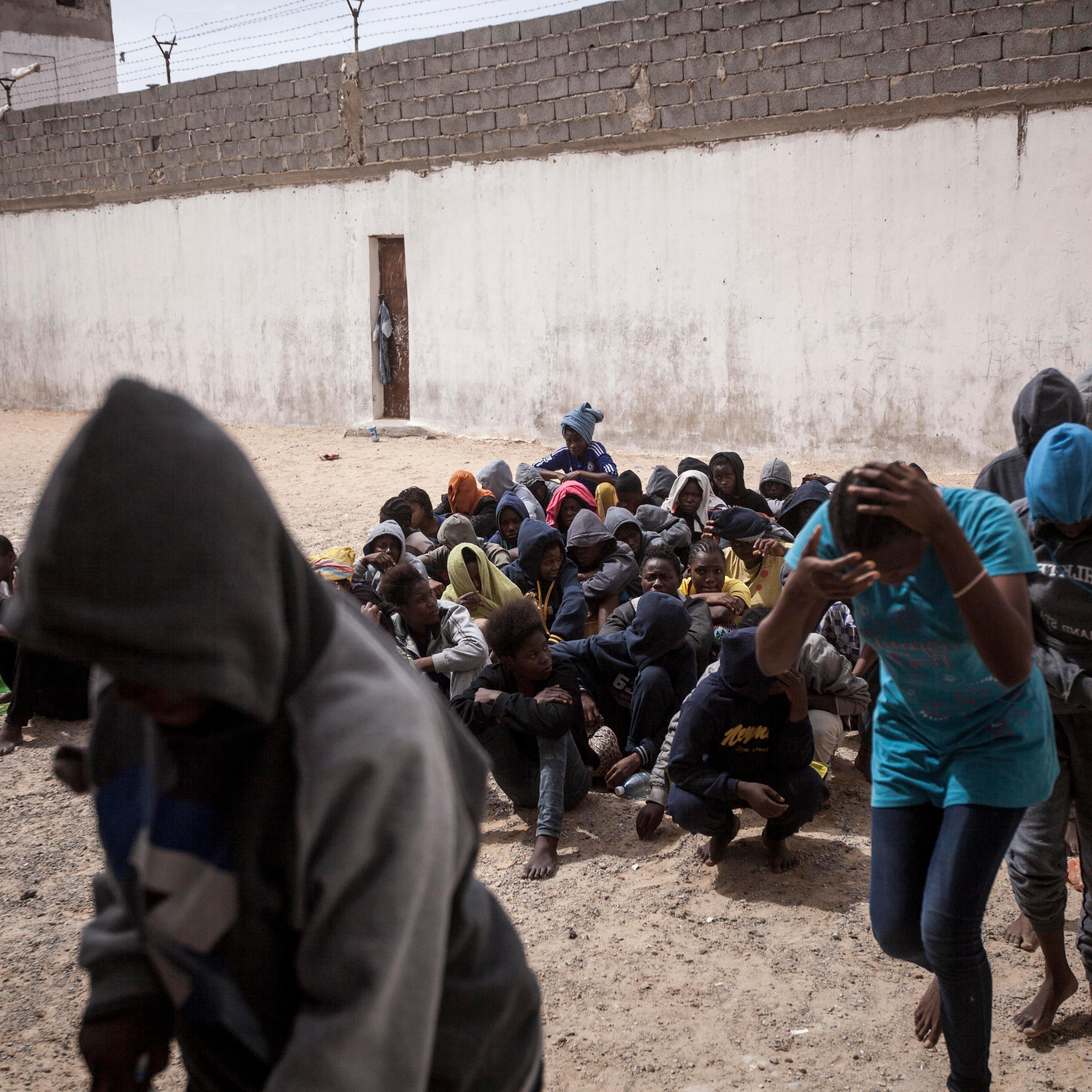 Women refugees and migrants queue in the prison yard as they are loaded onto buses to be transferred to another detention center. They were sold by a militia group ruling the Surman detention camp, Libya.