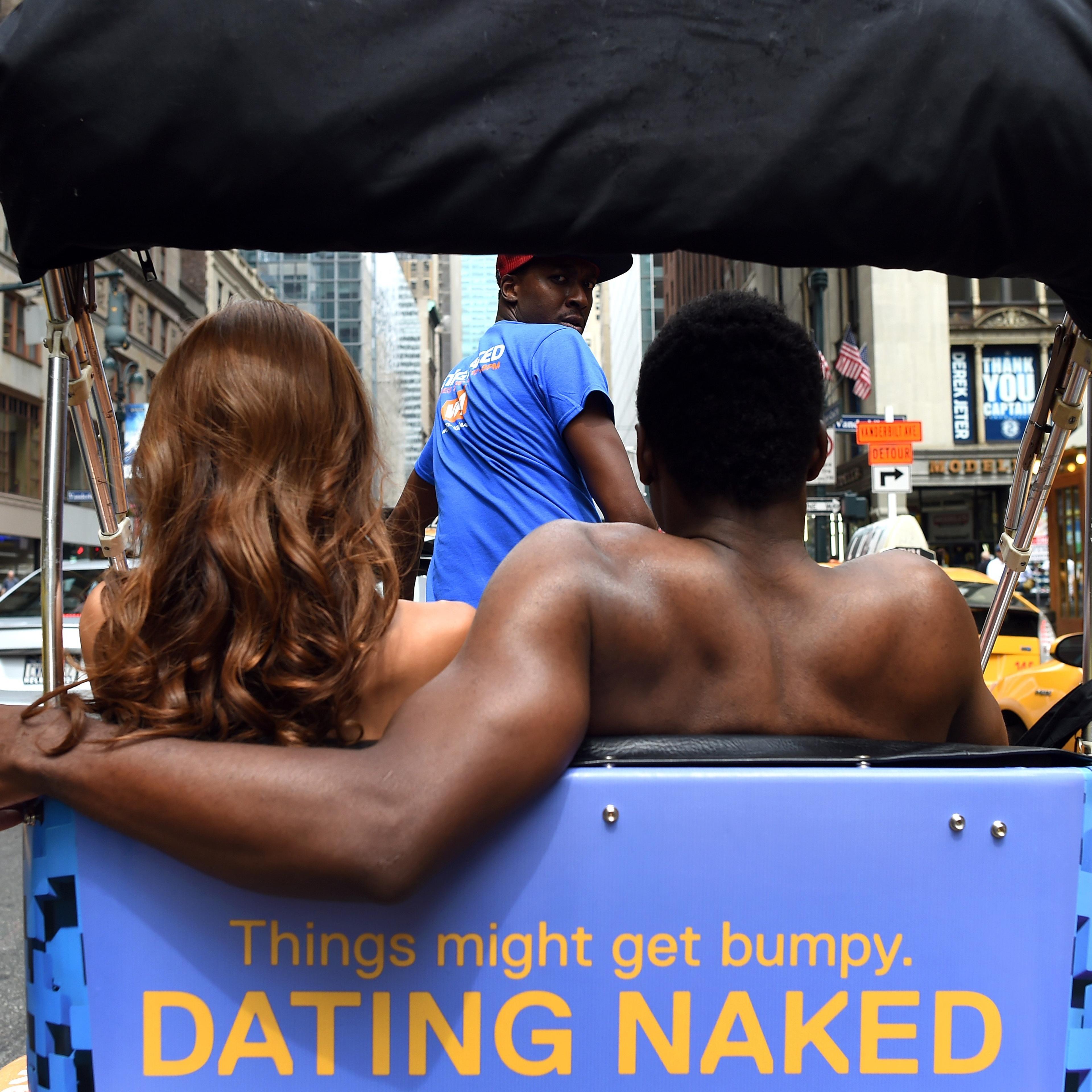 Kelly Keodara and Yarc Lewinson ride around Grand Central Station in New York City on July 16, 2014 in a pedicab to promote a new VH1 series "Dating Naked".