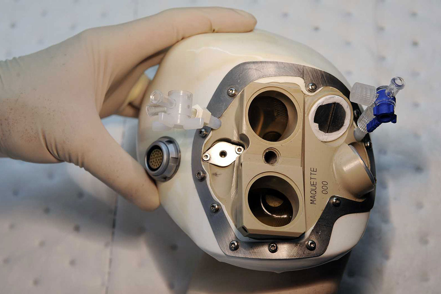 An employee of the French CARMAT company inspects an artificial heart on Sept. 24, 2009 in Velizy, Paris suburb
