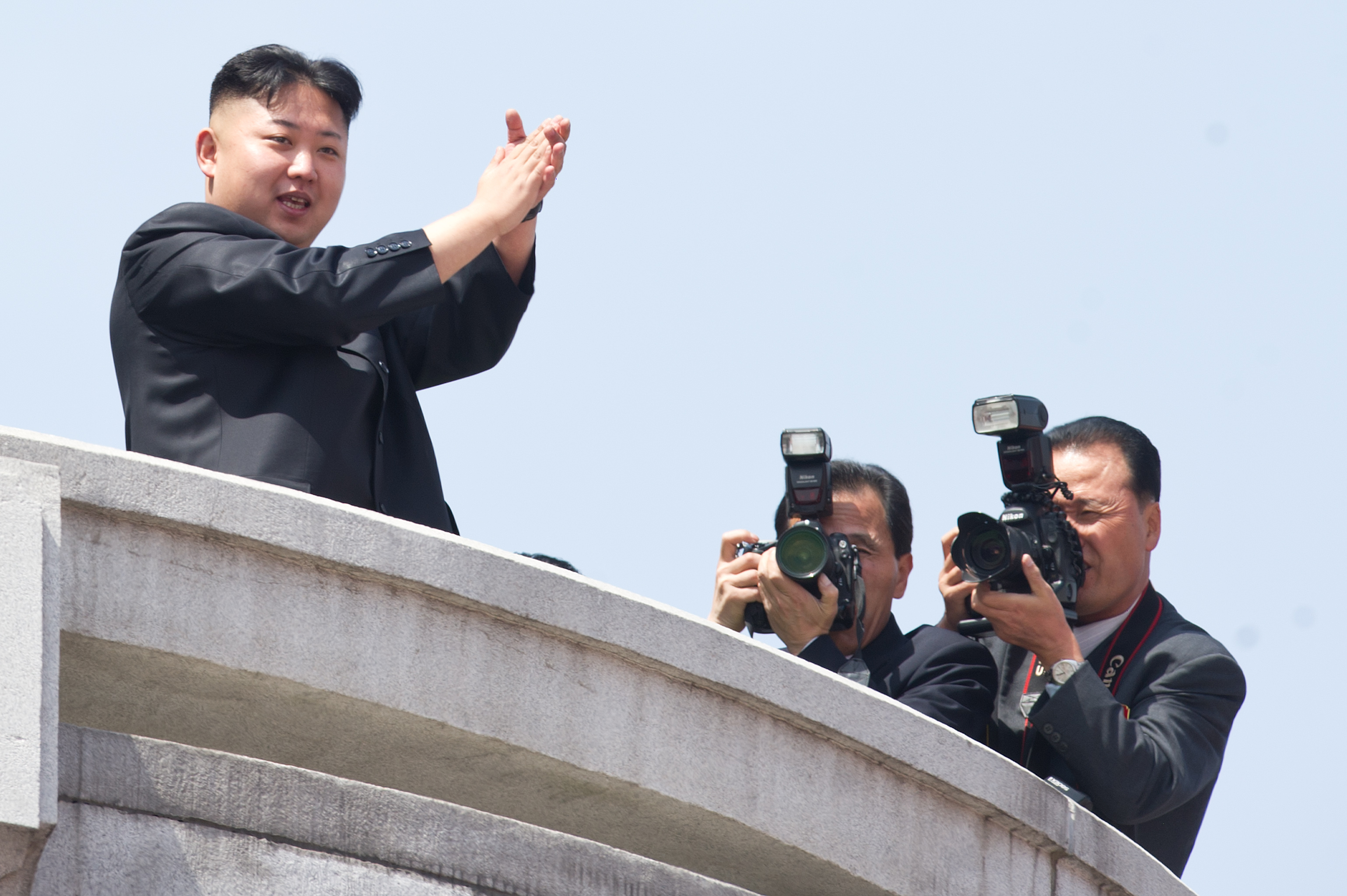 North Korean leader Kim Jong-Un (L) appl