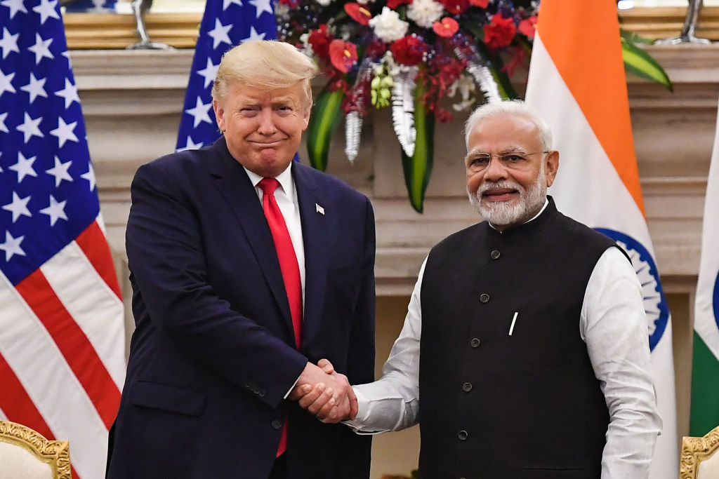 India's Prime Minister Narendra Modi shakes hands with former U.S. President Donald Trump before a meeting at Hyderabad House in New Delhi on Feb. 25, 2020.