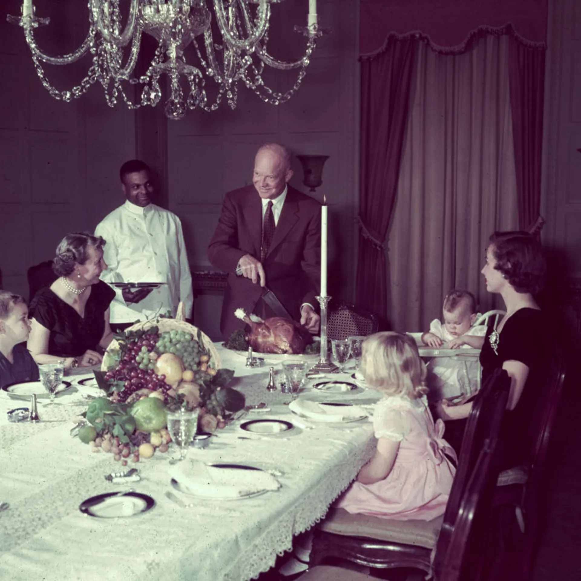 President Eisenhower Cutting Turkey for Family Dinner