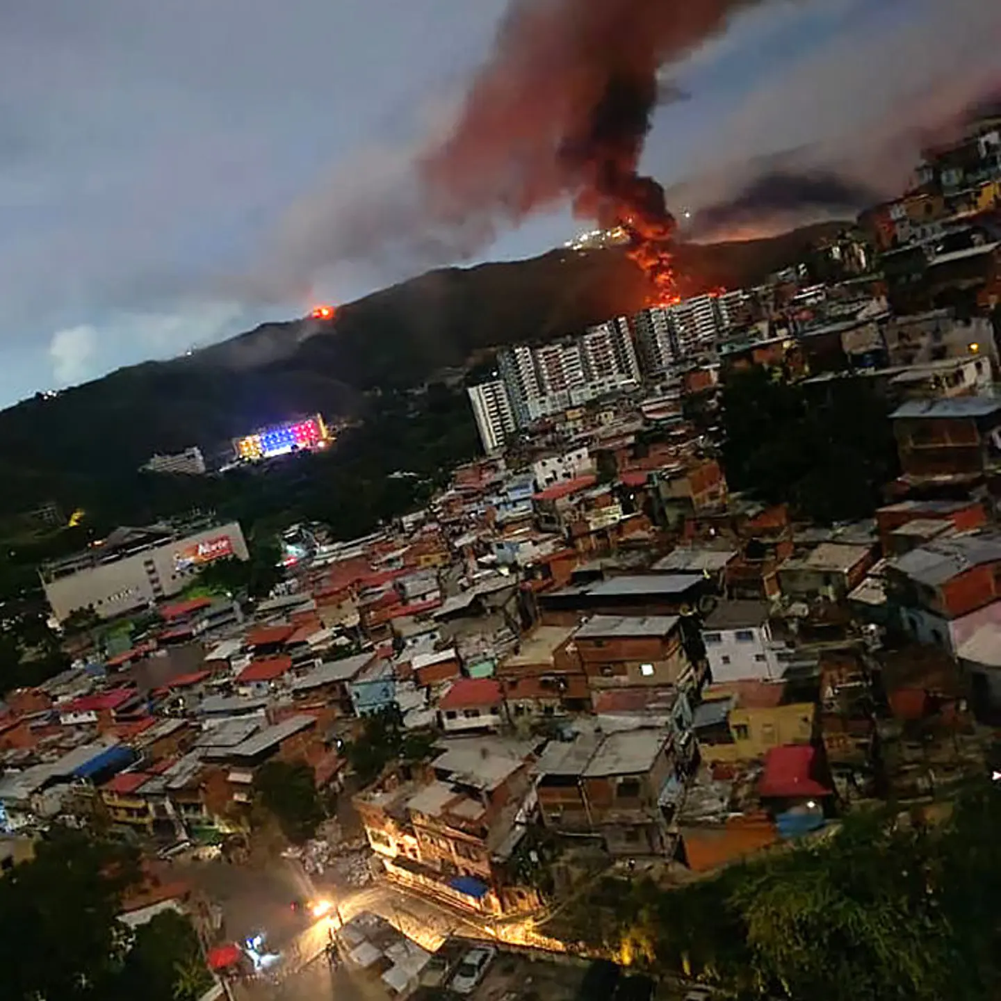 Fire at Fuerte Tiuna, Venezuela's largest military complex, is seen from a distance after a series of explosions in Caracas on Jan. 3, 2026.