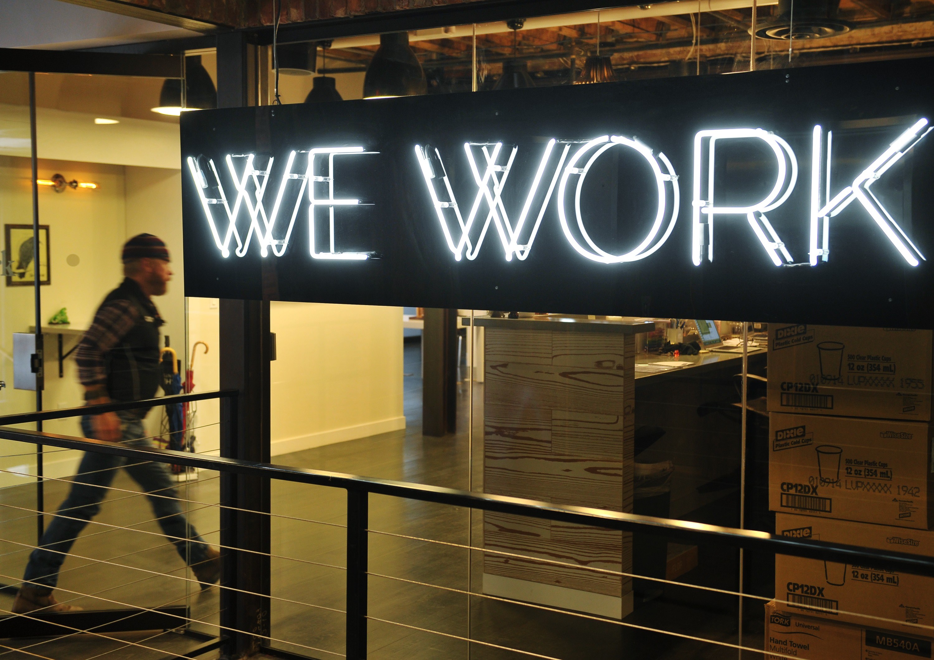 A man enter the doors of the "WeWork" co-operative co-working space on March 13, 2013 in Washington, DC.