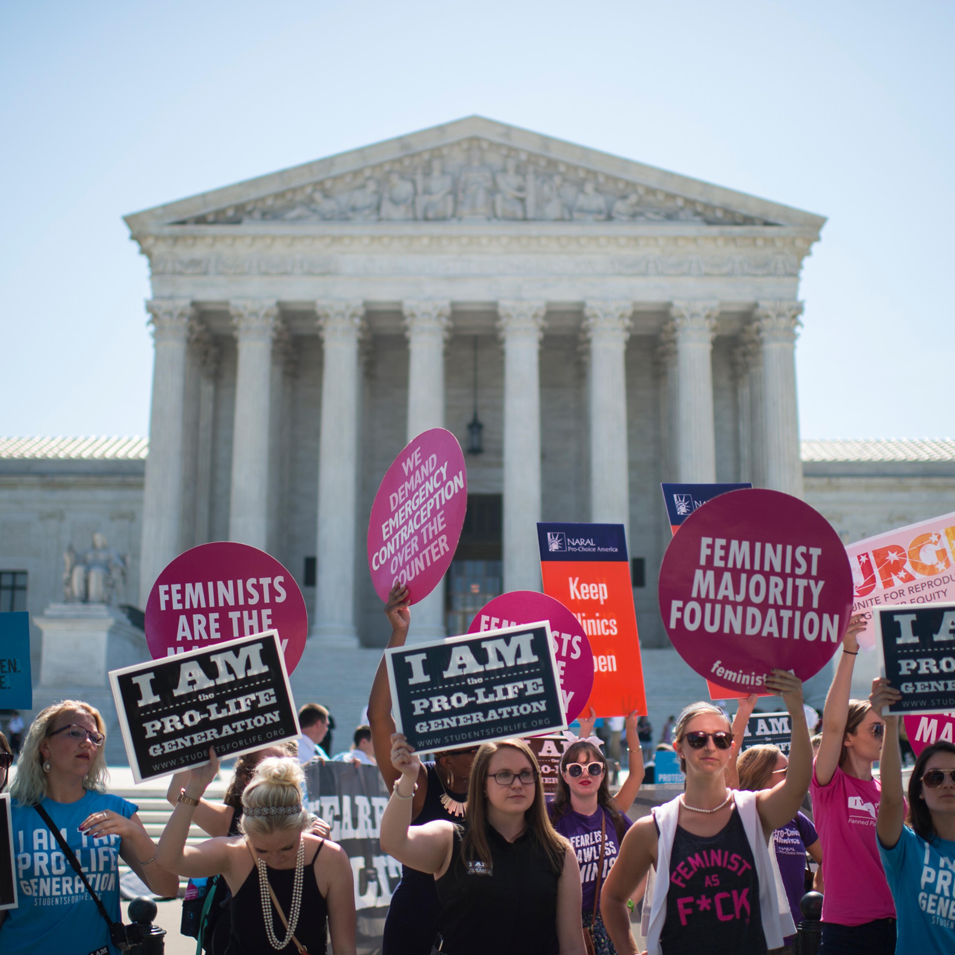 Pro-choice and pro-life demonstrators rally outside of the U.S. Supreme Court on Monday morning, June 20, 2016. The court is expected to hand down their decision on a Texas law which requires clinics to meet the same standards as ambulatory surgical cent