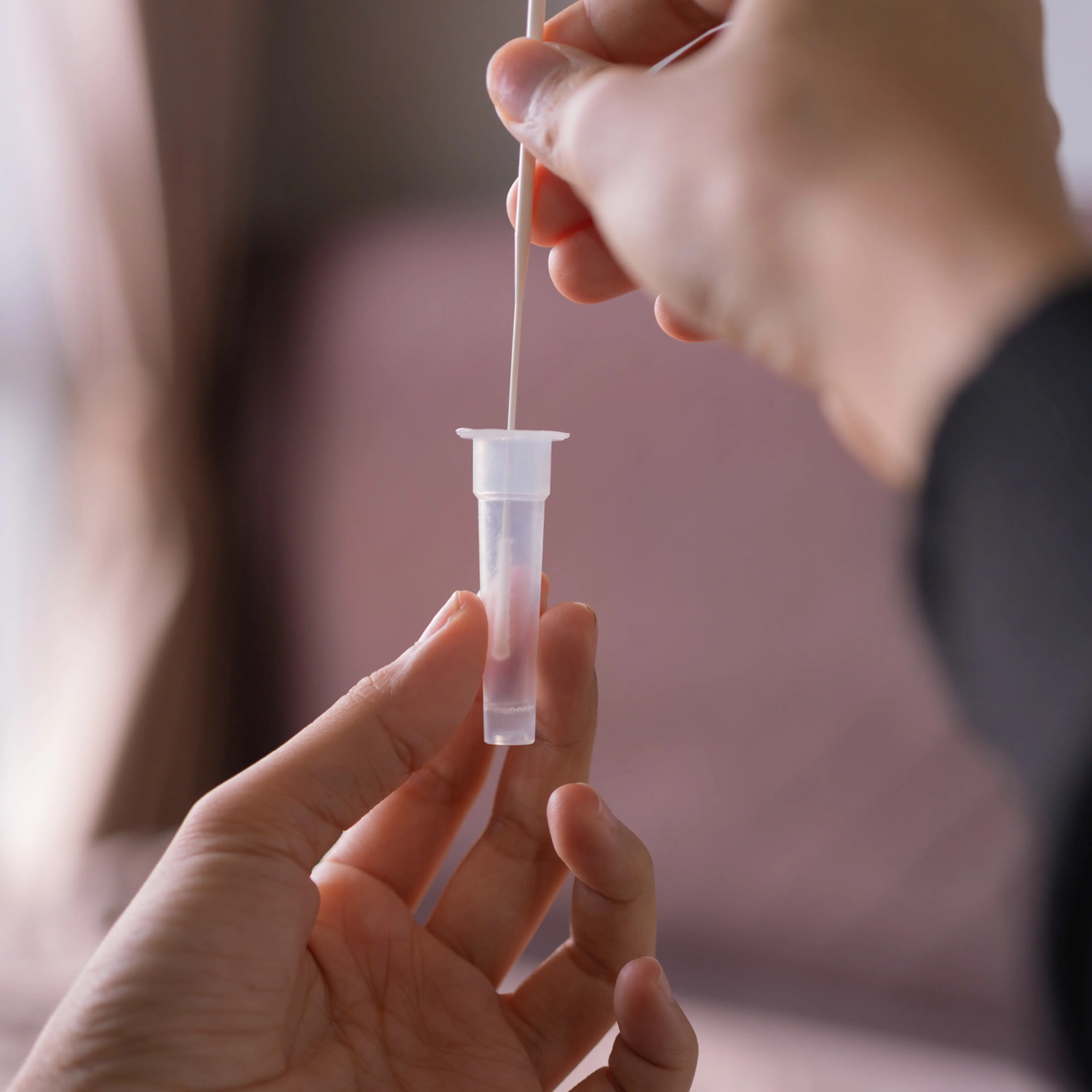 A person performs an at-home COVID-19 test.