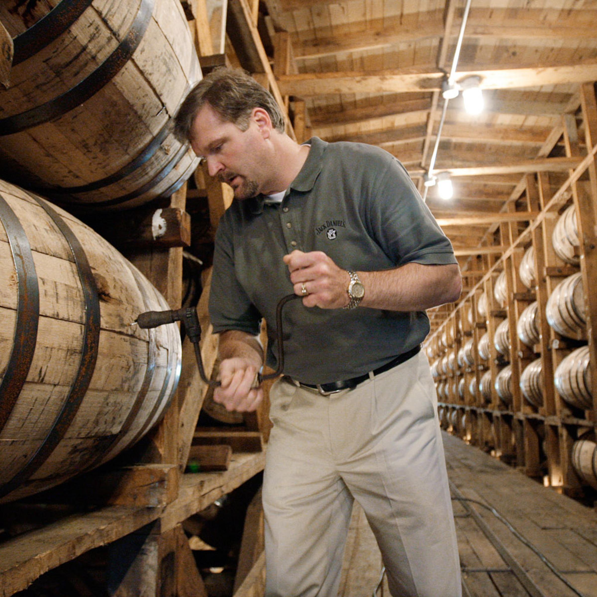 Jeff Arnett, the master distiller at the Jack Daniel Distillery in Lynchburg, Tenn., drills a hole in a barrel of whiskey in one of the aging houses at the distillery, May 20, 2009.
