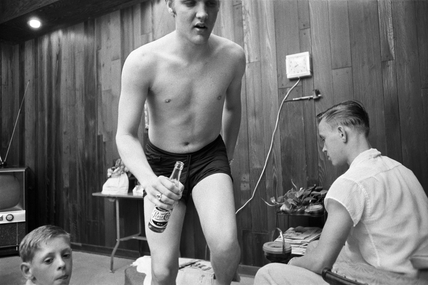 July 4, 1956. 1034 Auburn Drive, Memphis. I call it Pepsi in hand, which it is. This is [Elvis at home] with his cousin, Billy Smith (left), who’s still alive, and Bobby Smith (right), who committed suicide. He took rat poison. I was told he was jealous of Elvis for some reason and wondered why he too couldn't become famous.