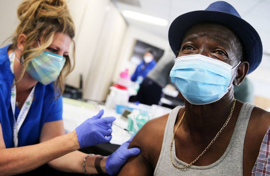 Larry Green receives his second dose of the Moderna COVID-19 vaccine from registered nurse Teresa Frey at Lincoln Memorial Congregational Church UCC on March 12, 2021 in Los Angeles, California.