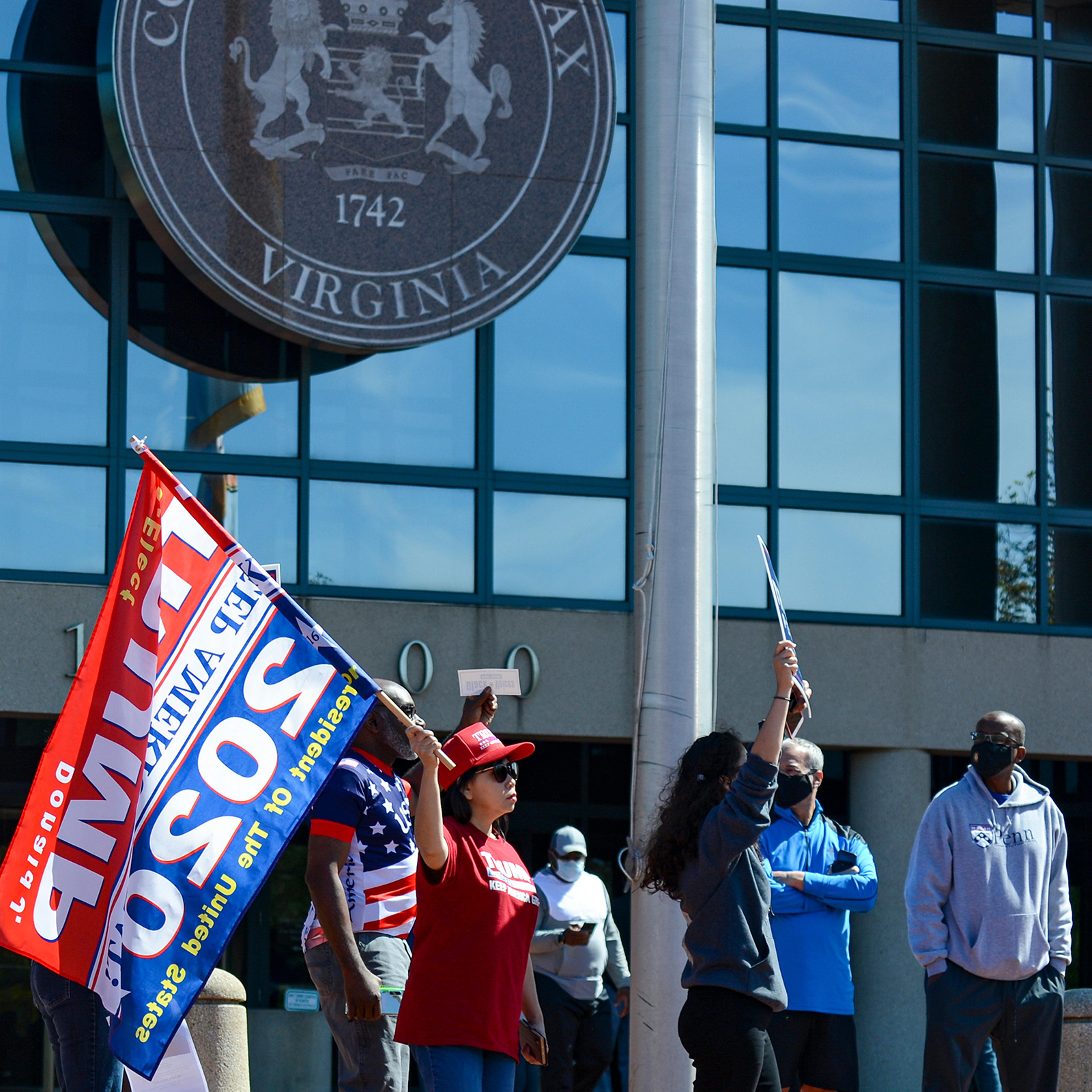 Trump supporters chant, “Four more years,” on Sept. 19 outside the Fairfax County Government Center in Fairfax, Va., disrupting early voting