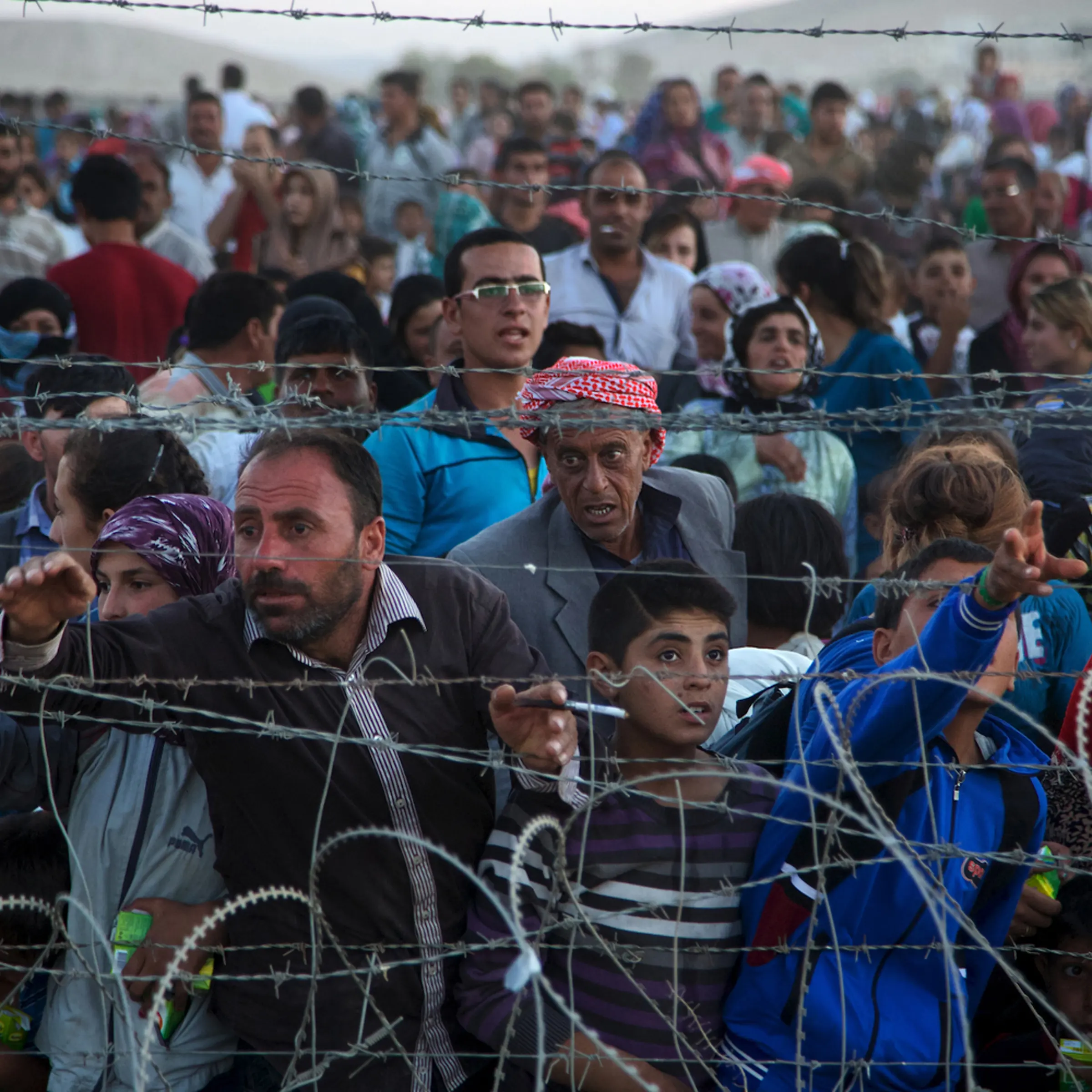 Up to 5,000 Syrians from Kobani amass at the border with Turkey on Friday evening, next to the Turkish village of Dikmetas.