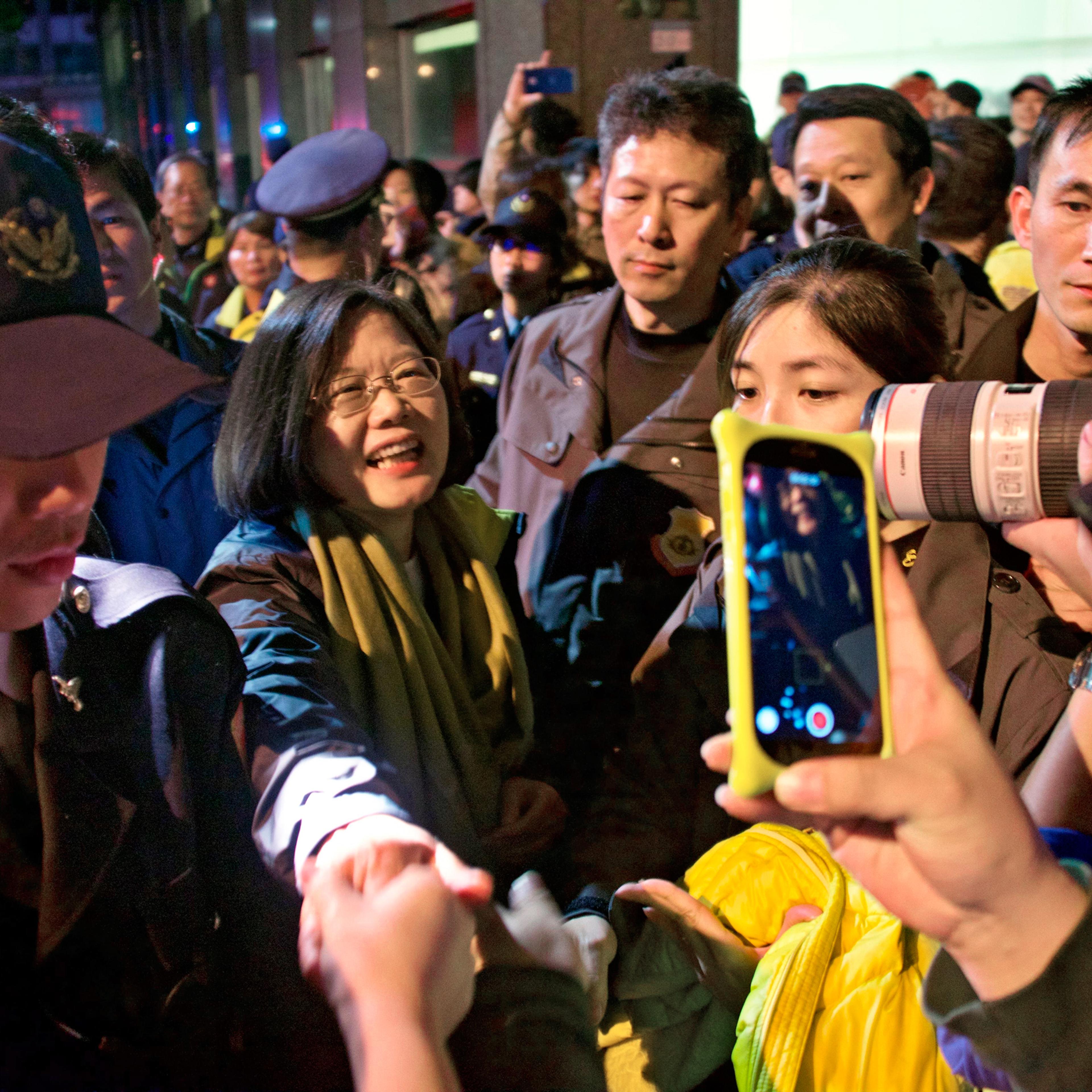 Tsai Ing-wen greets members of the public on January 16, 2016, as she leaves the DPP headquarters celebrations in Taipei, Taiwan.