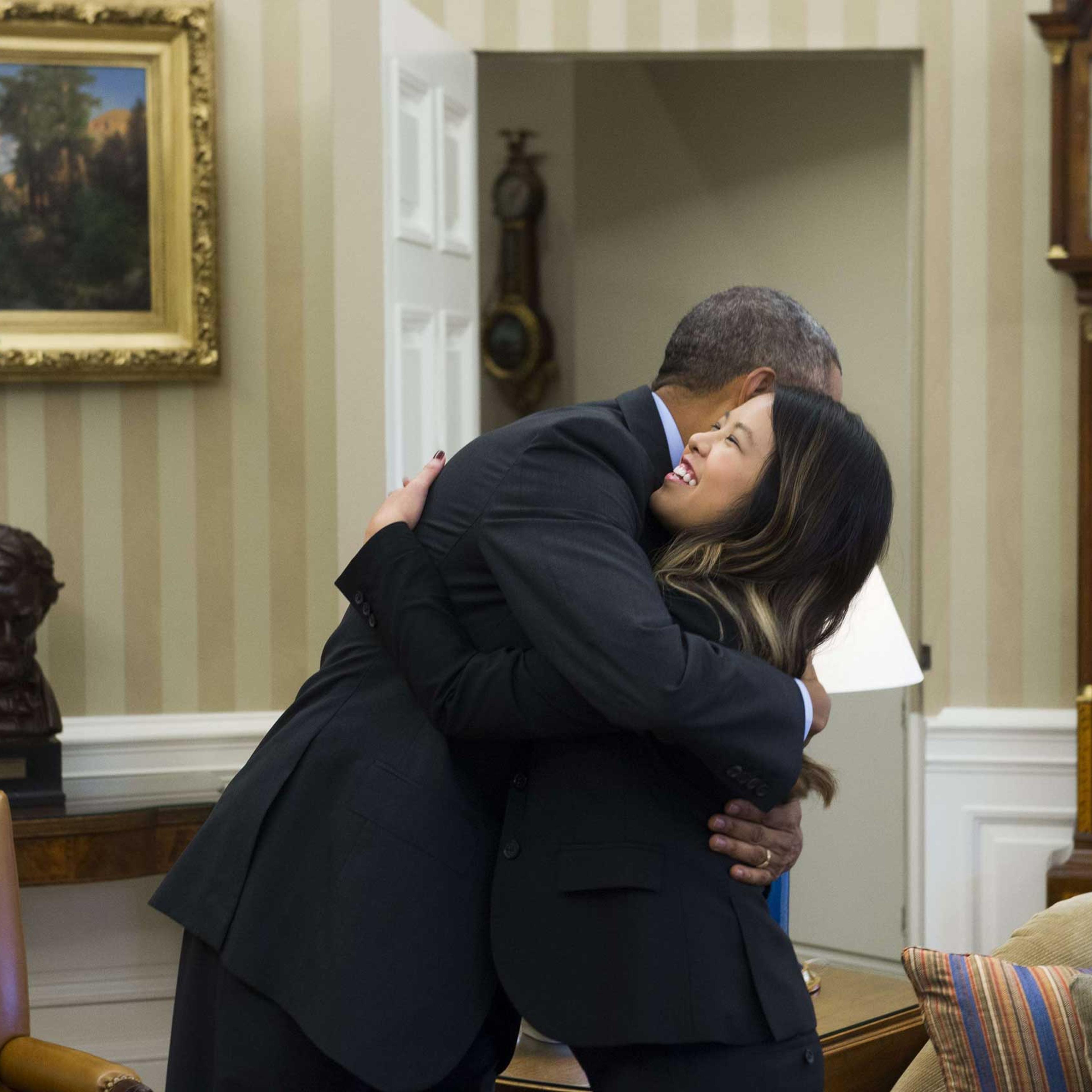 President Barack Obama hugs nurse Nina Pham, who was declared free of the Ebola virus after contracting the disease while caring for a Liberian patient in Texas, during a meeting in the Oval Office in Washington on Oct. 24, 2014.