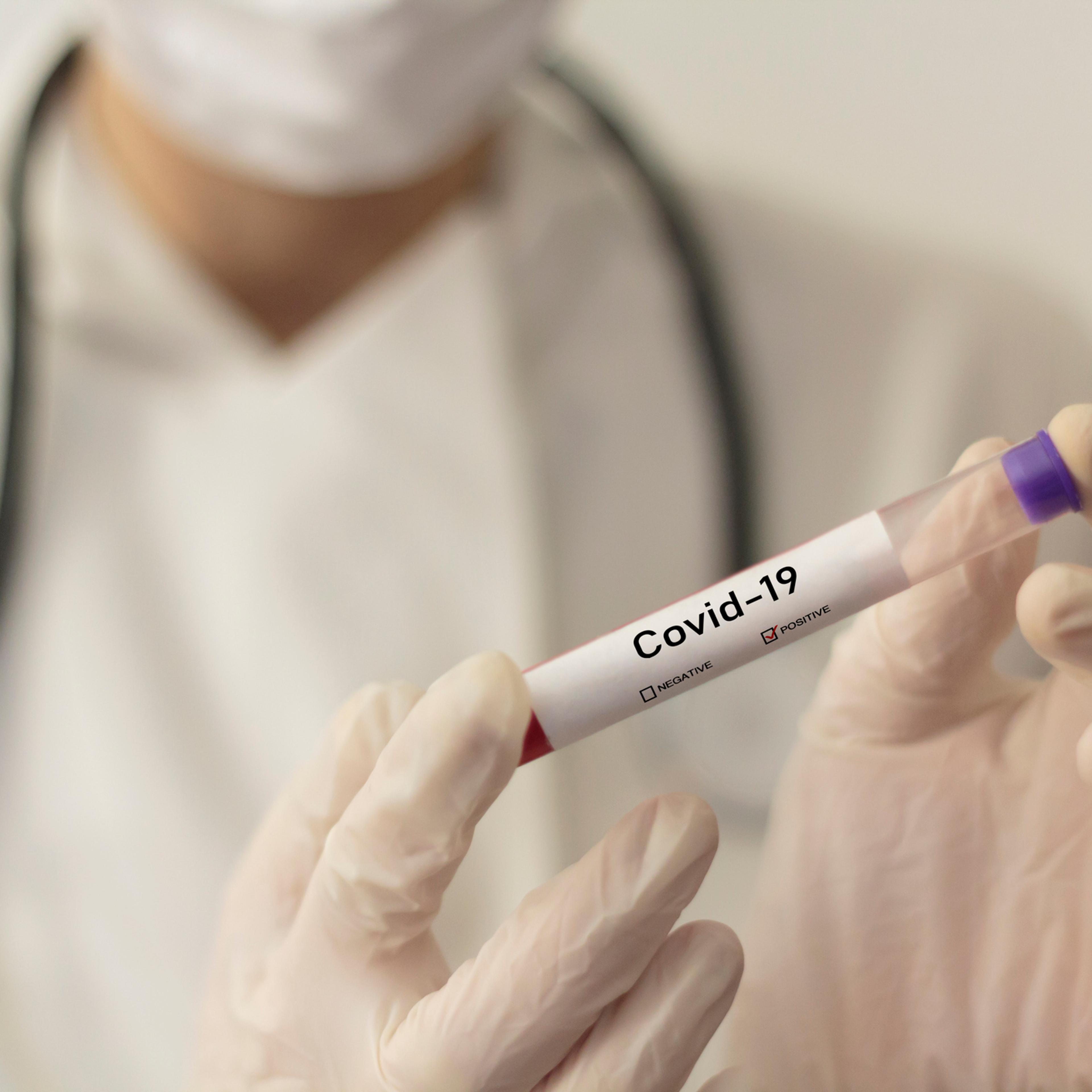 Midsection Of Doctor Holding Test Tube In Laboratory