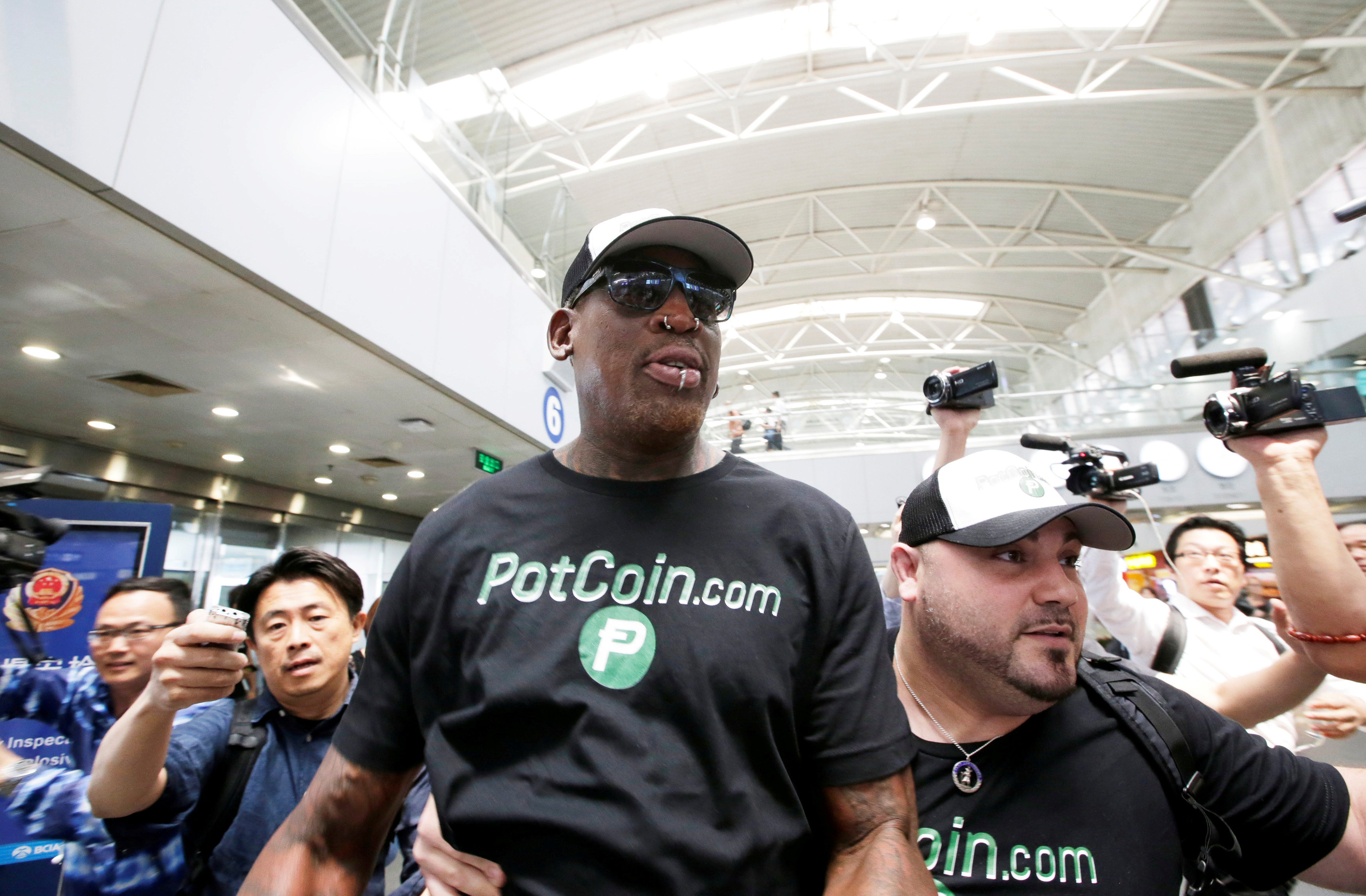Former NBA basketball player Dennis Rodman arrives at Beijing Capital International Airport as he leaves for North Korea's Pyongyang in Beijing