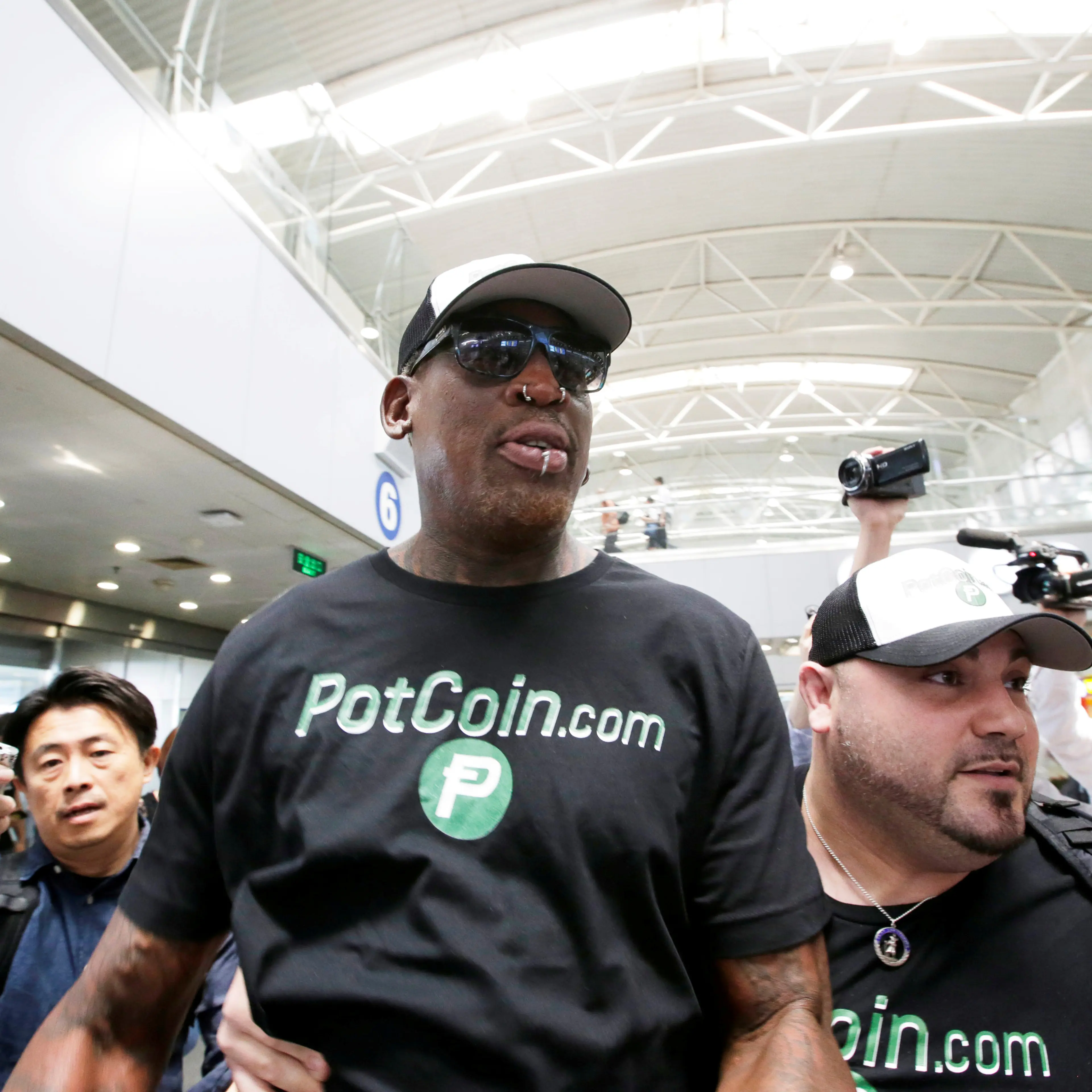 Former NBA basketball player Dennis Rodman arrives at Beijing Capital International Airport as he leaves for North Korea's Pyongyang in Beijing