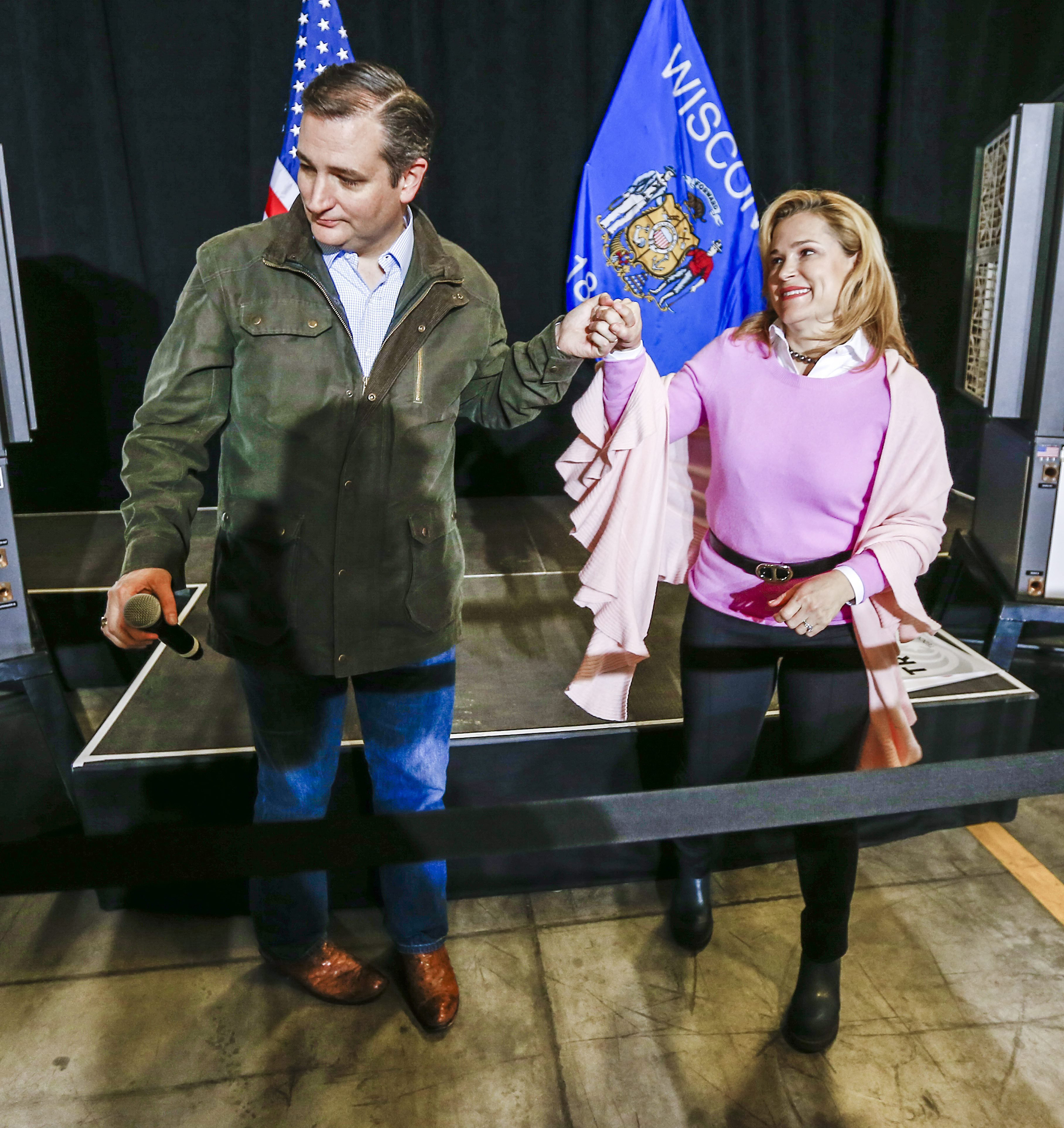 Texas Senator and Republican presidential candidate Ted Cruz holds the hand of his wife Heidi Cruz as he finishes speaking at a campaign stop at Dane Manufacturing in Dane, Wisconsin on March 24, 2016.
