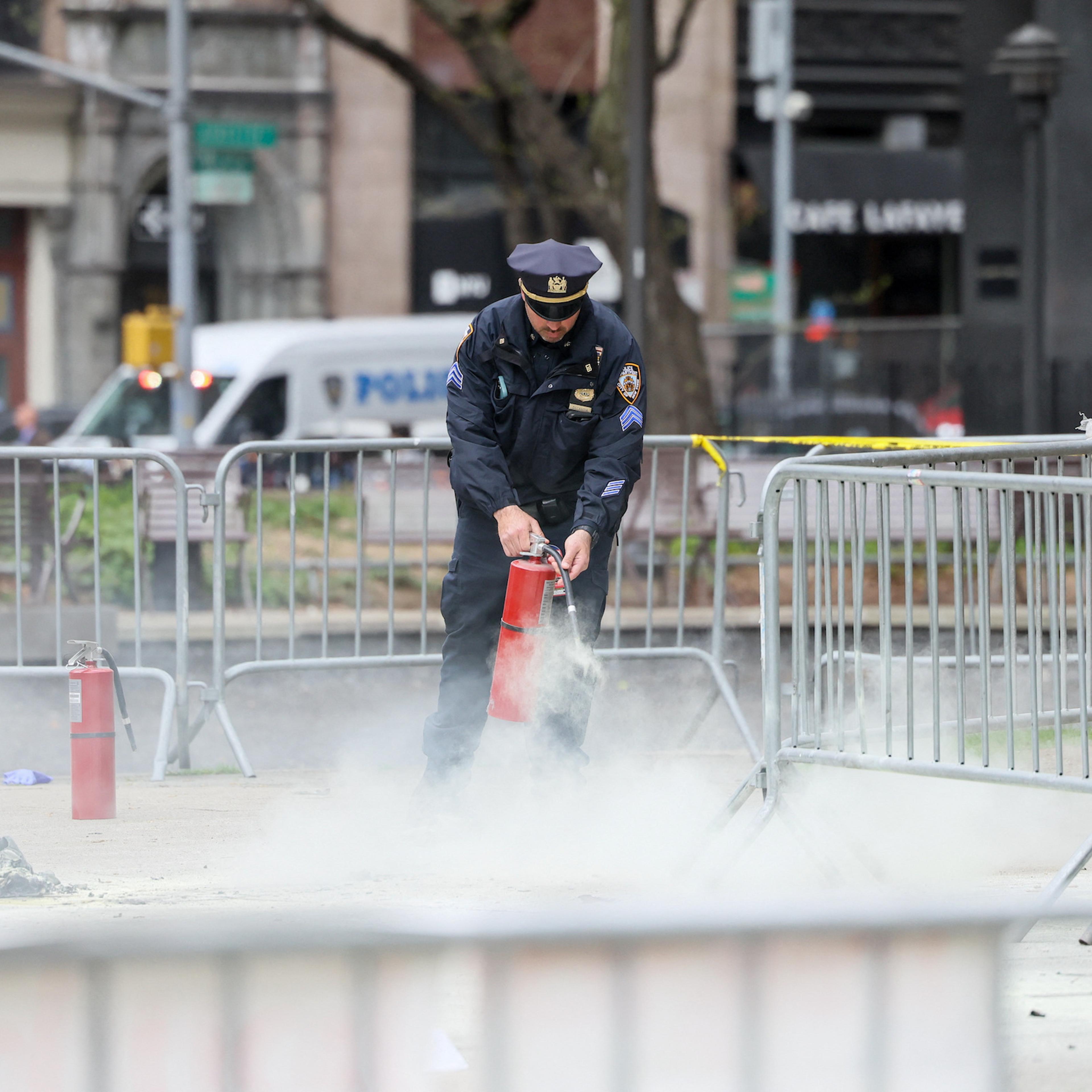 Aftermath of a person covered in flames outside NY courthouse of former U.S. President Trump's criminal hush money trial